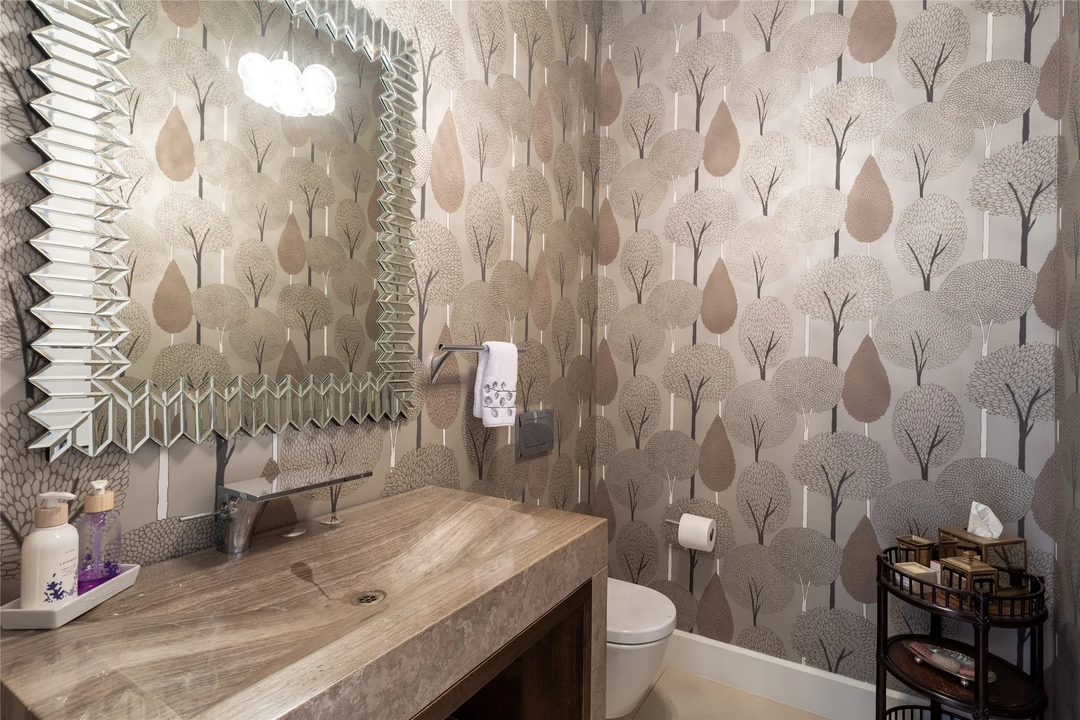 Powder Bath has Limestone Quartz vanity with waterfall faucet & Harlequin Boutique Silhouette wallcovering.