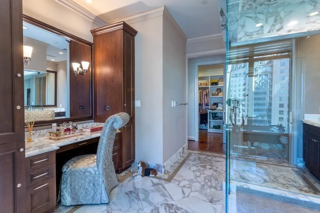 Primary Bath boasts a make-up table, jetted tub, & two water closets.