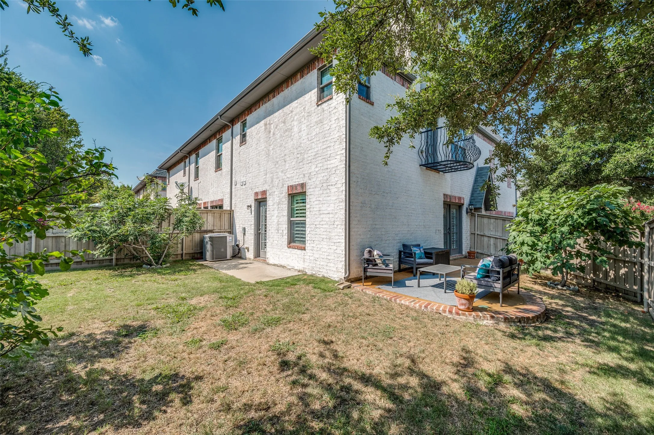 Large backyard with many shady trees