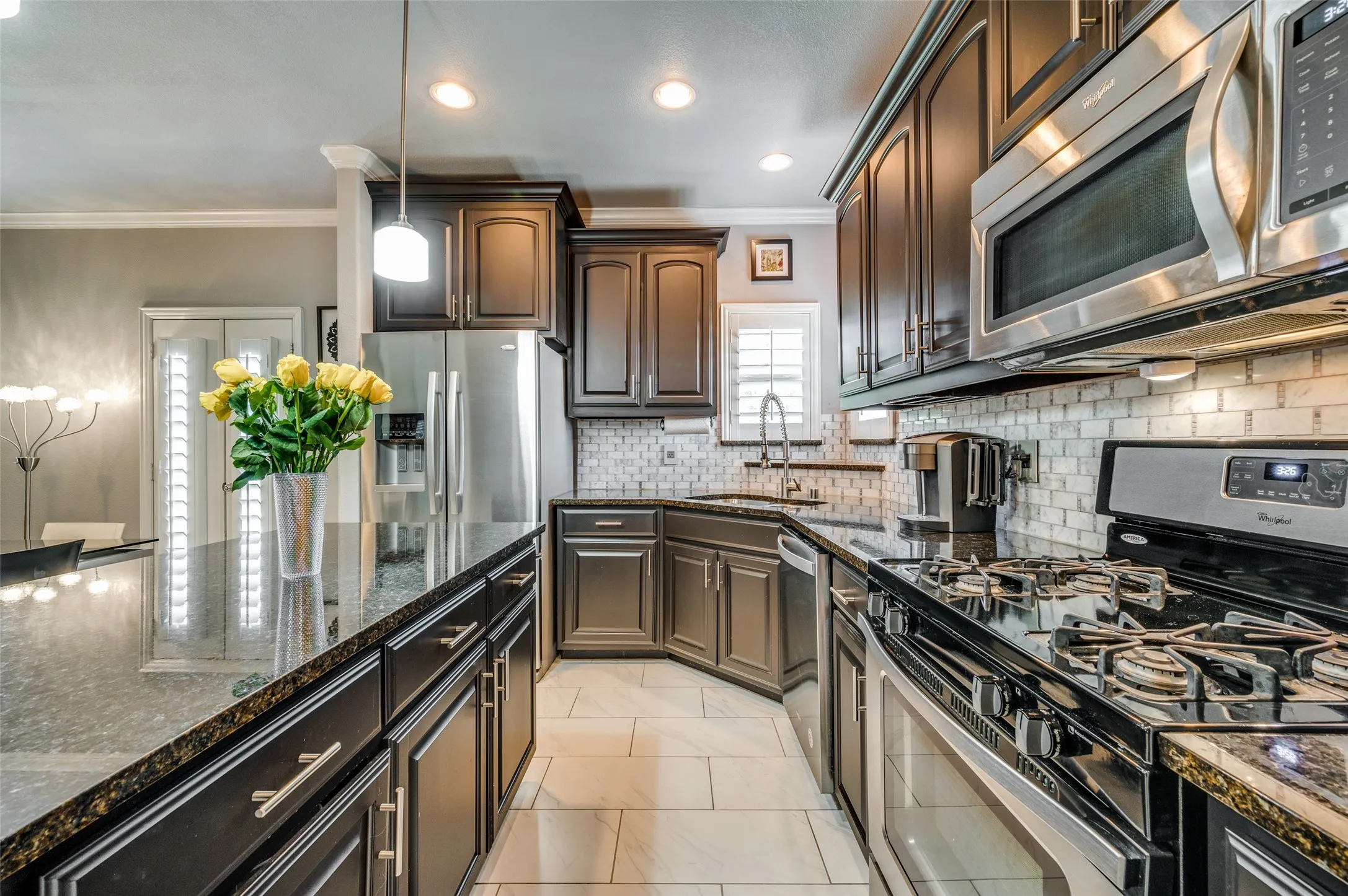Crisp, clean dark cabinetry remains a classic kitchen look and this space doesn't disappoint in either its look or its functionality.