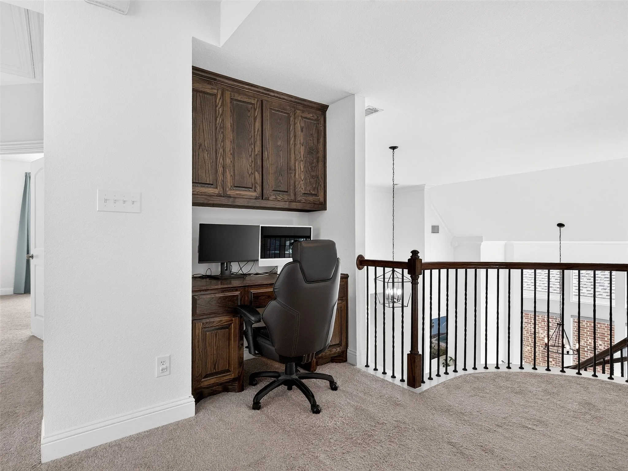 Built-in desk with dark wood cabinetry