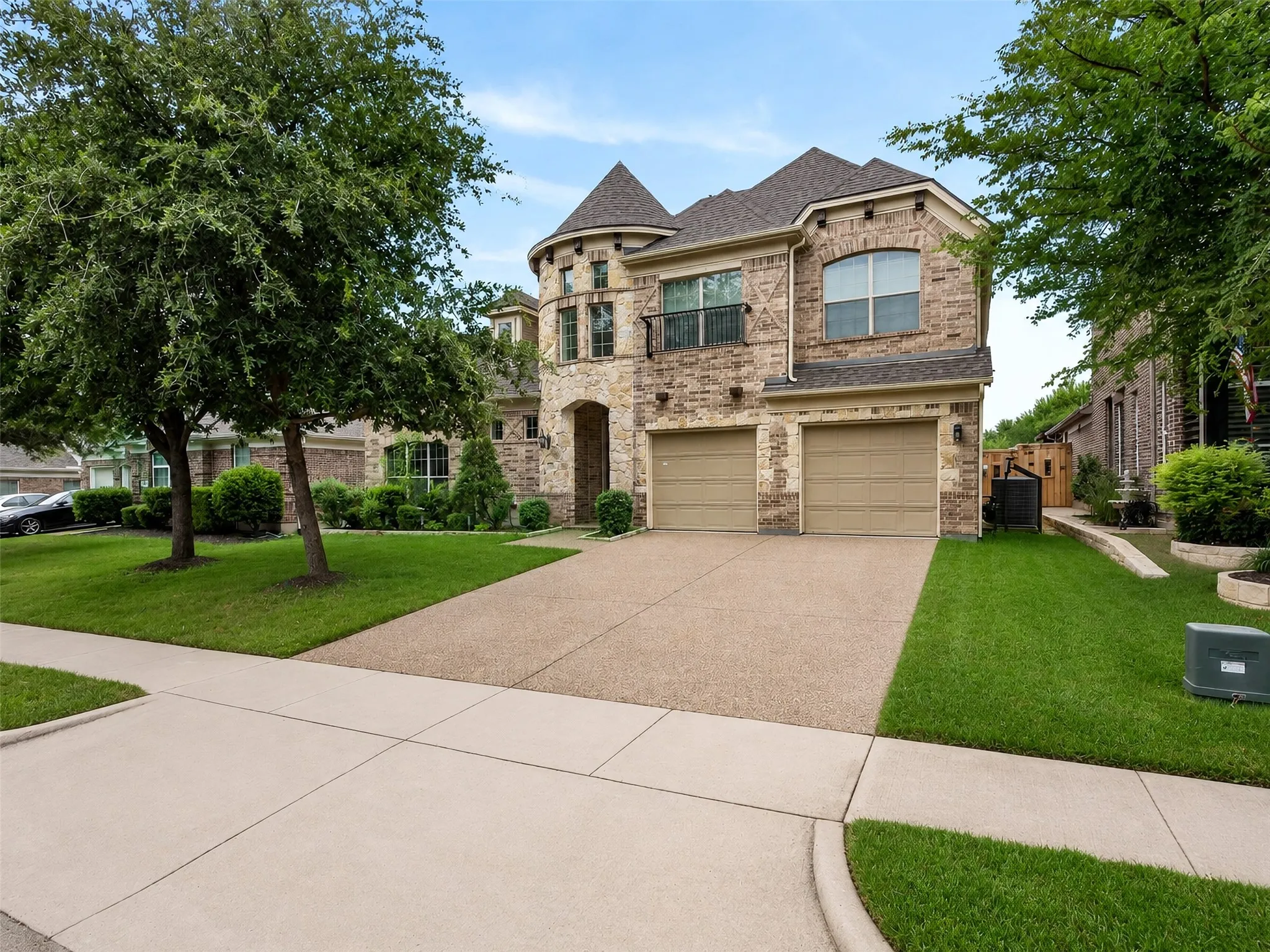 Stone and brick exterior with a turret feature and arched entry