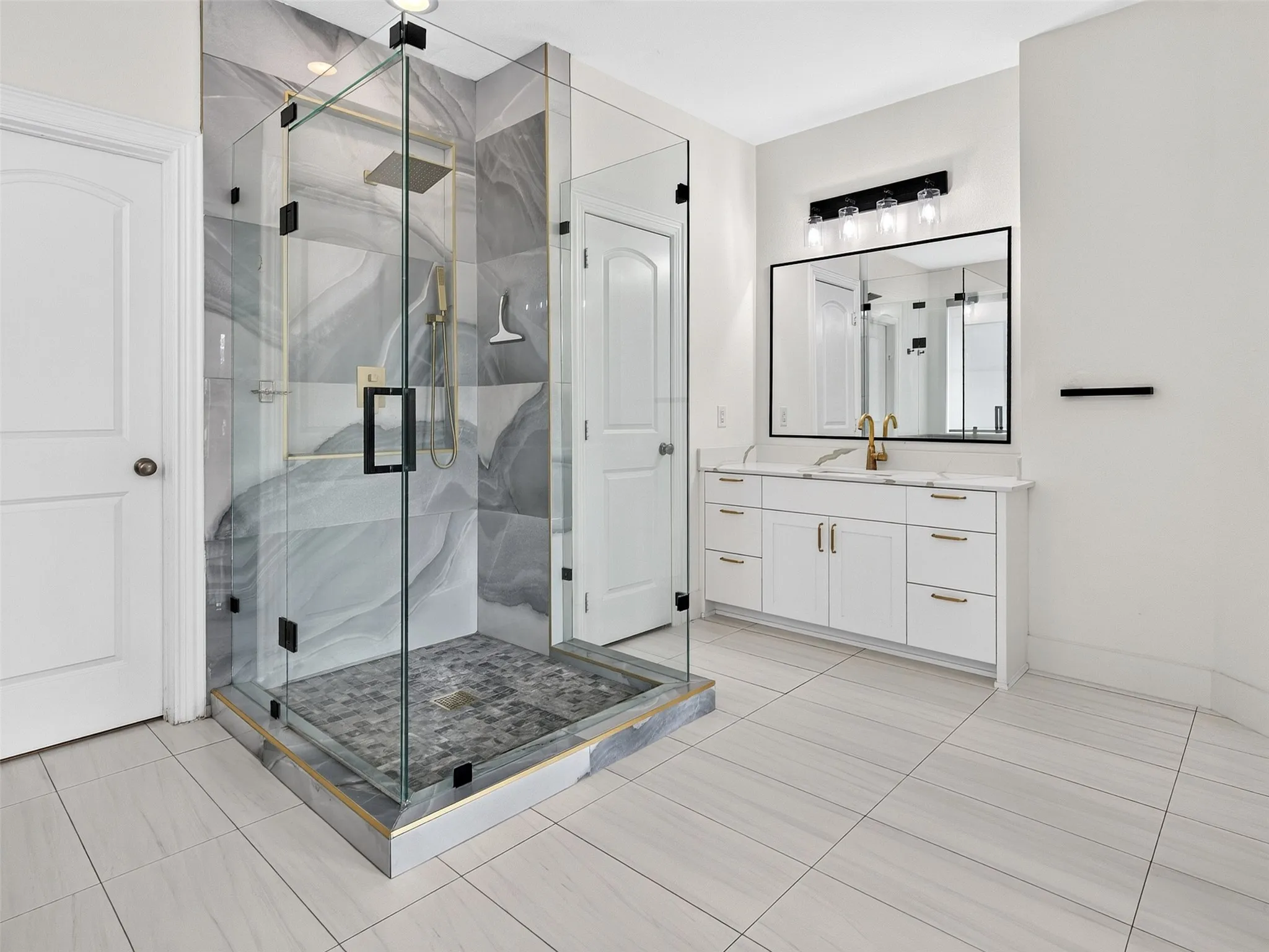 Spacious bathroom featuring a glass-enclosed shower with abstract-patterned wall tiling and a rainfall showerhead
