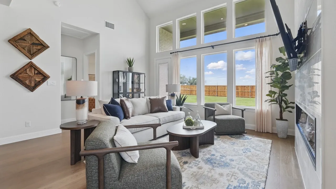 Expansive living area featuring a vaulted ceiling and wood-finish flooring