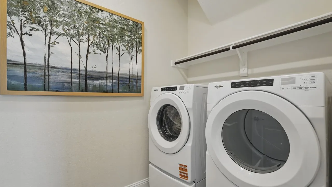 Dedicated laundry area featuring a white front-loading washer and dryer set