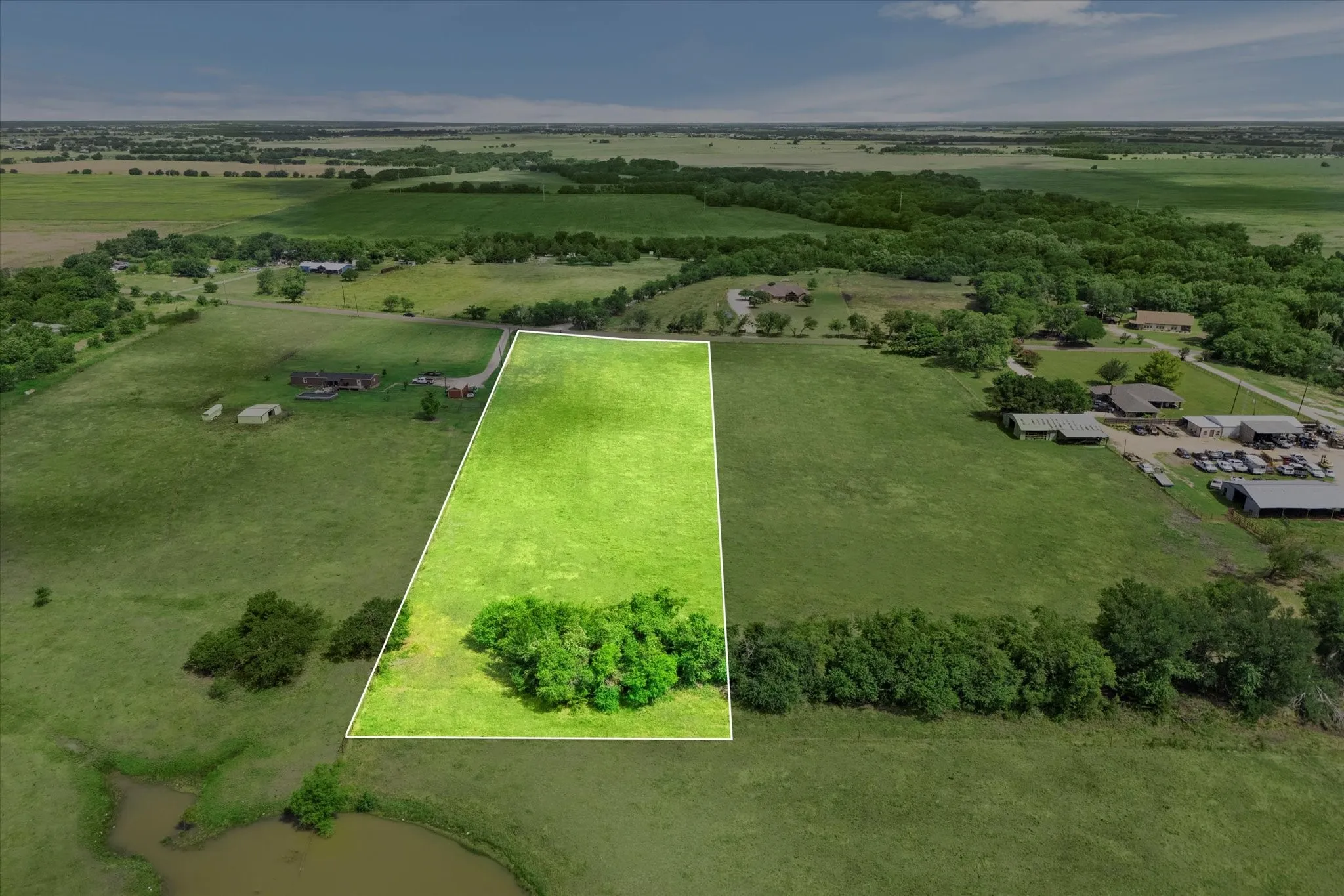 Property for sale extends past the tree line in the back.