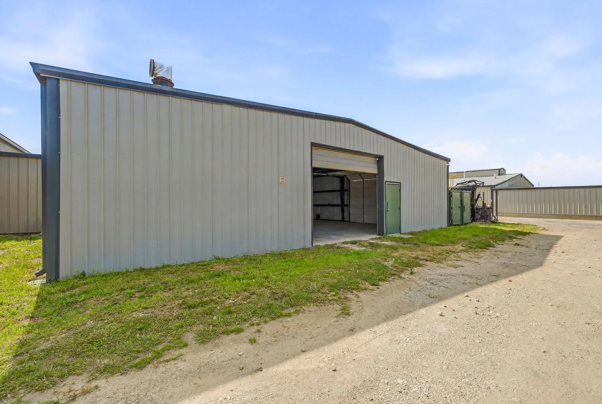 Rear view of the building and two 10' x 12' overhead doors and a walkin door