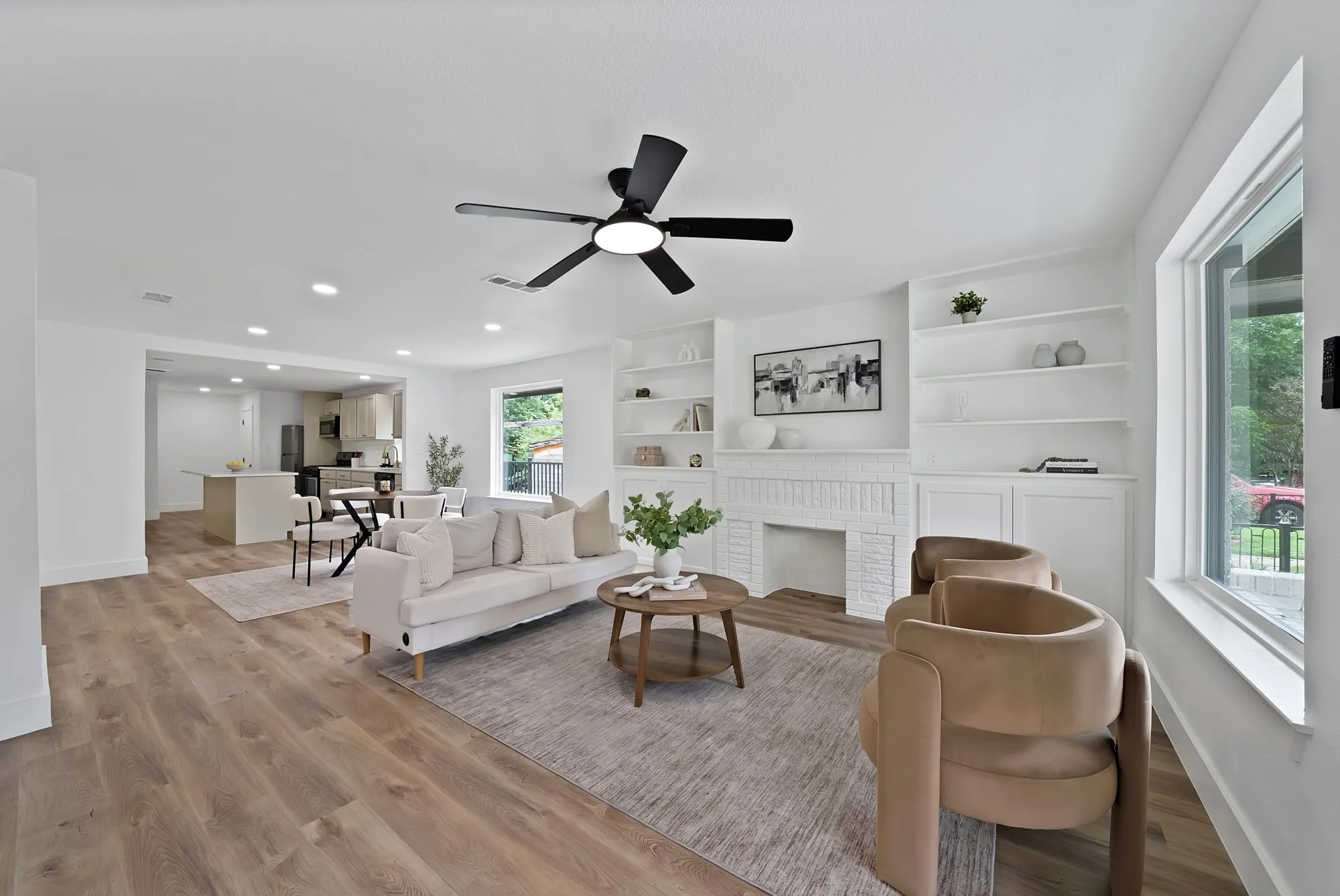 Spacious interior featuring wood-finish flooring, a contemporary ceiling fan, recessed lighting, and large windows