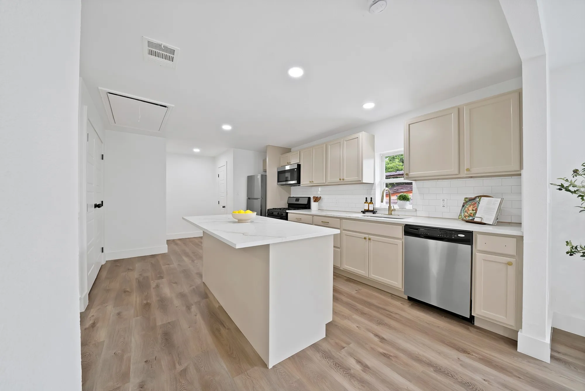 Modern kitchen with a central island featuring a white countertop