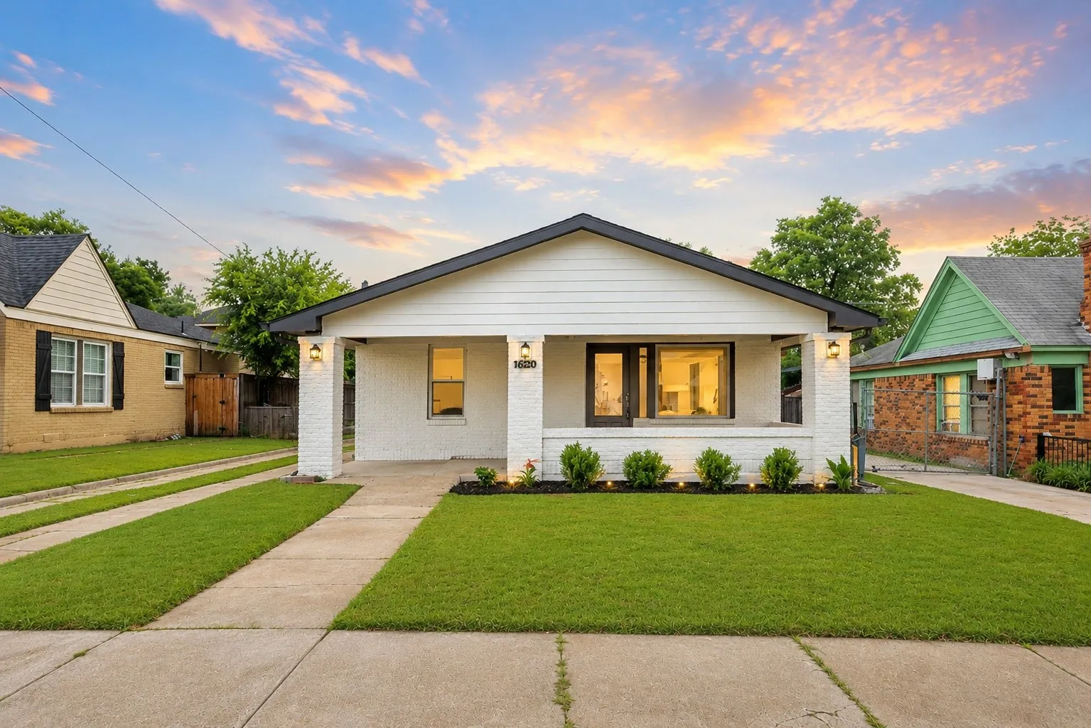 White-painted brick and horizontal siding exterior with a black-trimmed gable roof