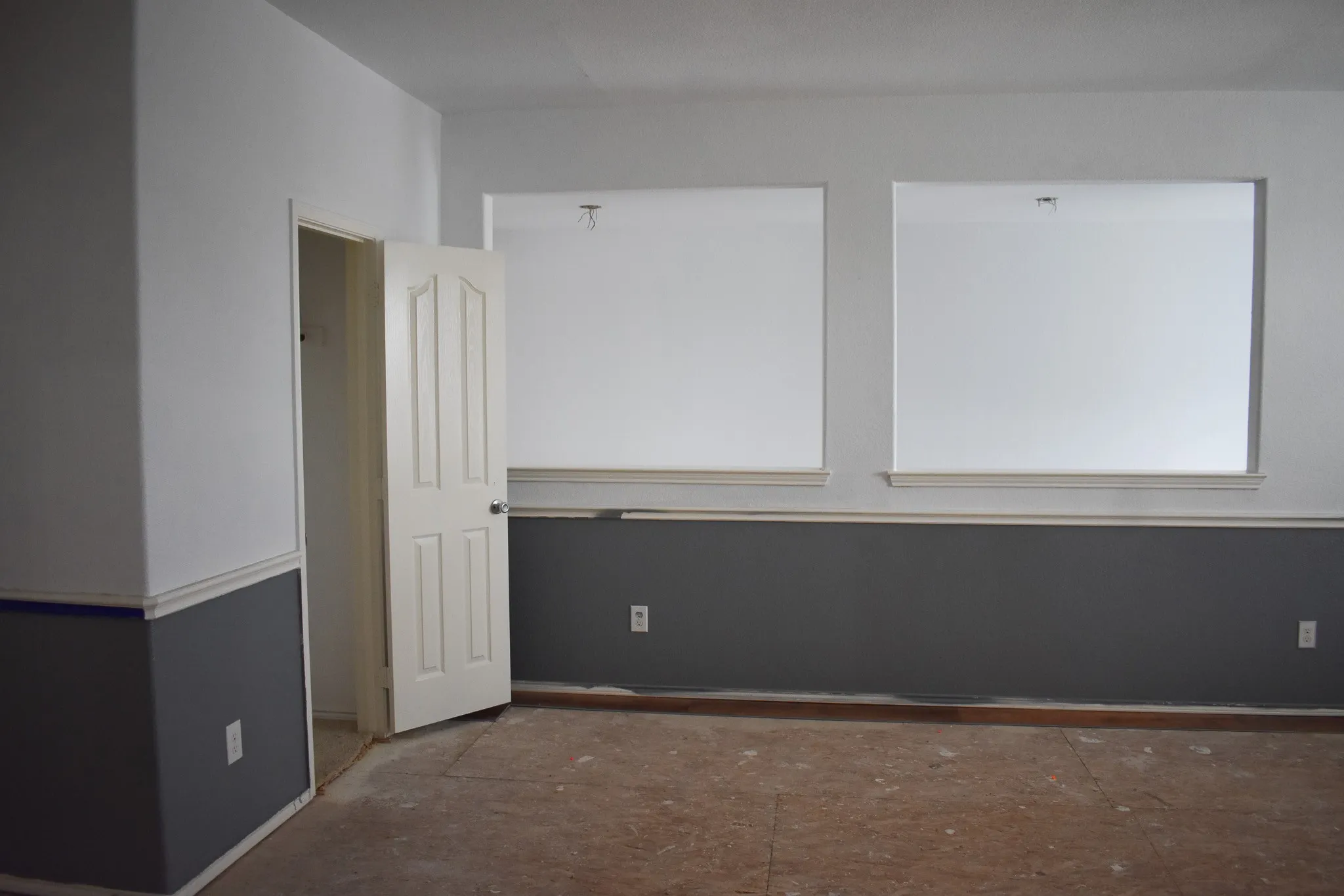 Interior room featuring a two-tone paint scheme with white walls and a contrasting gray wainscoting
