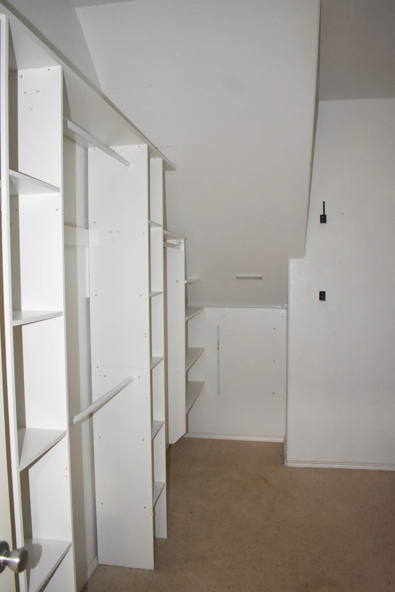 White shelving units with integrated hanging rods