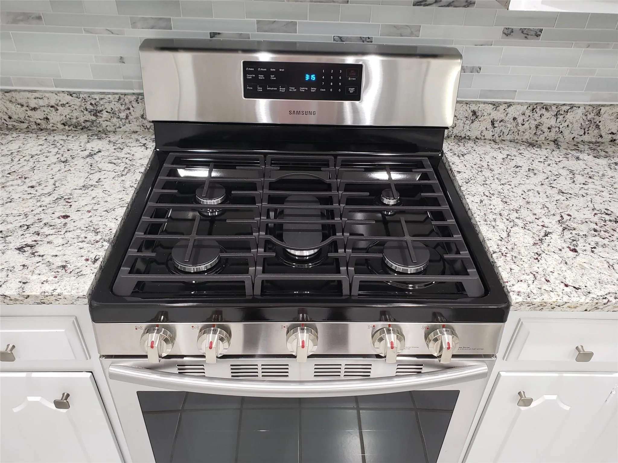 Gas stovetop with a convection oven.
