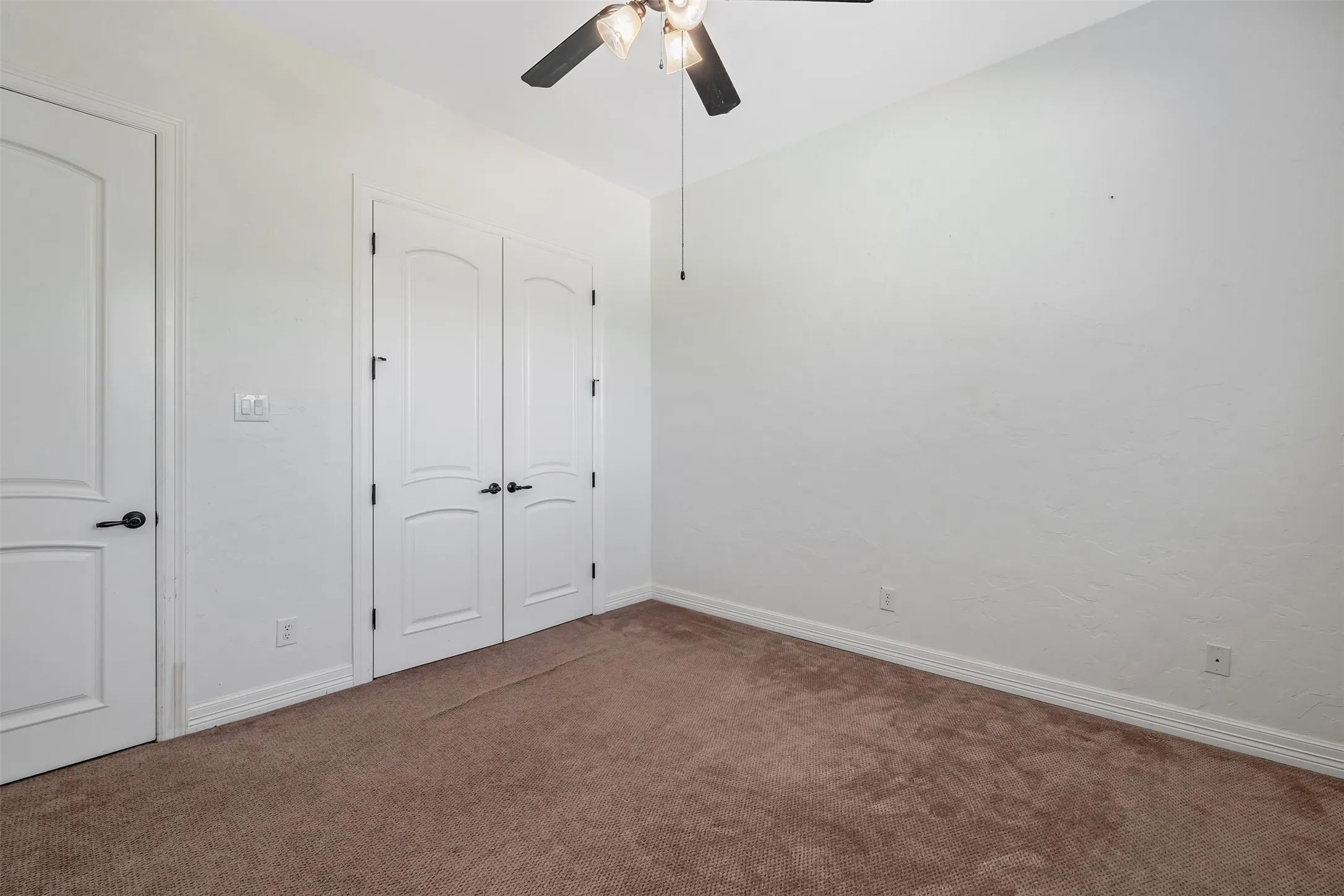 Neutral tone walls with brown carpet flooring