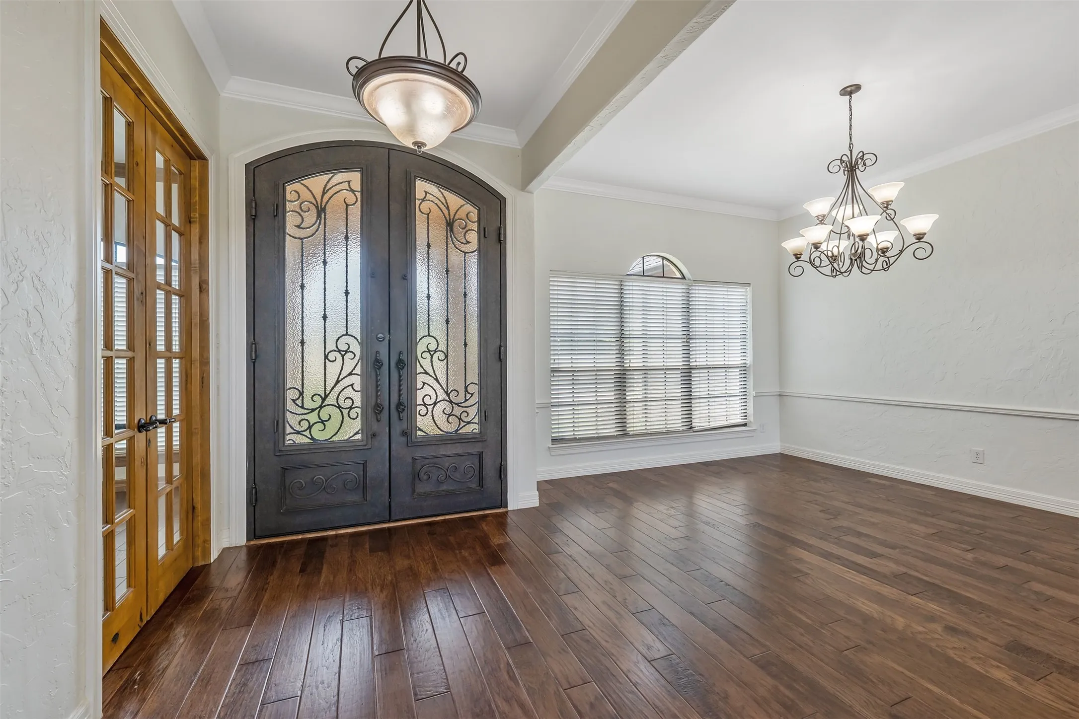 Double iron entry doors with decorative glass and scrollwork