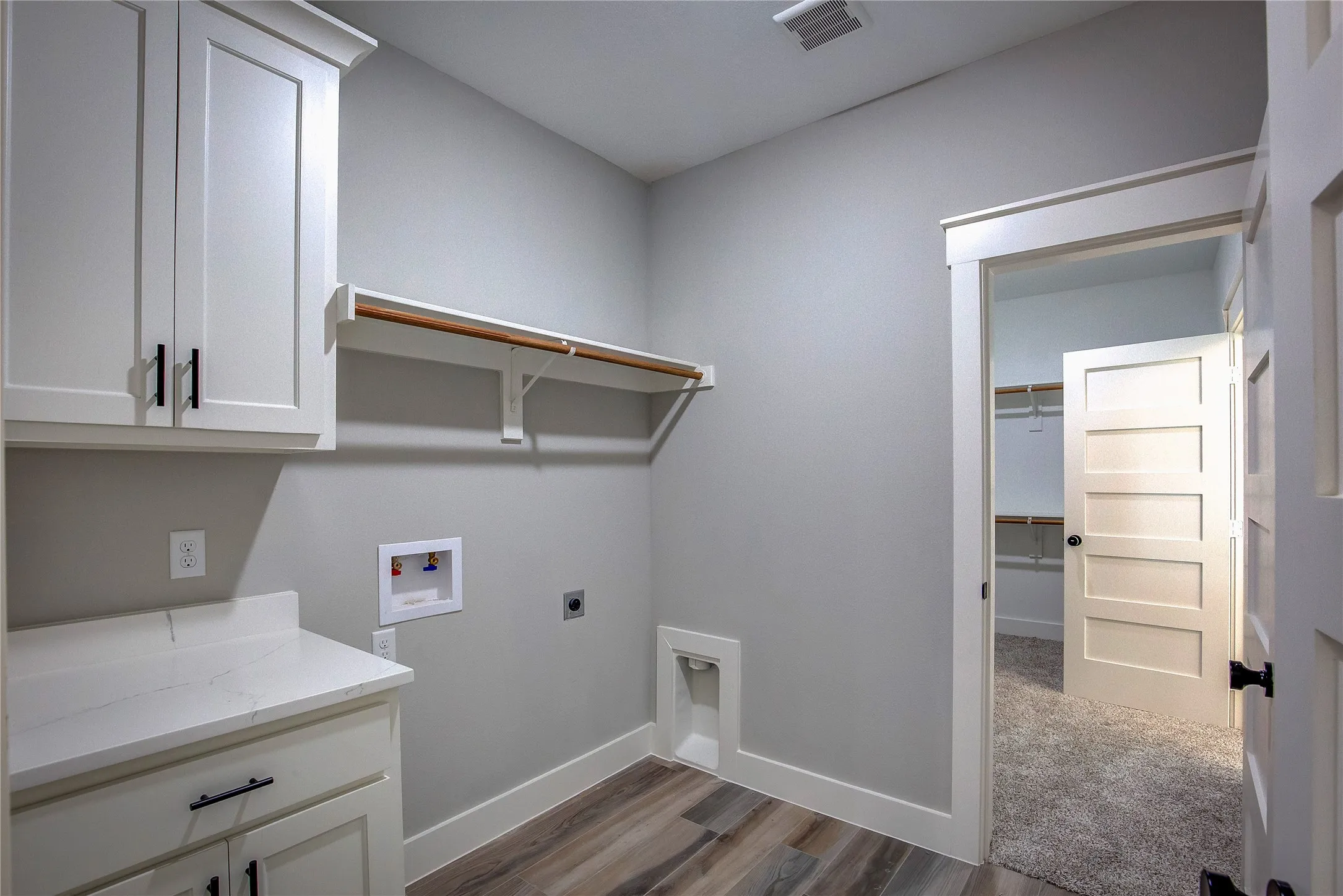 Laundry room with cabinets, carpet, electric dryer hookup, and hookup for a washing machine