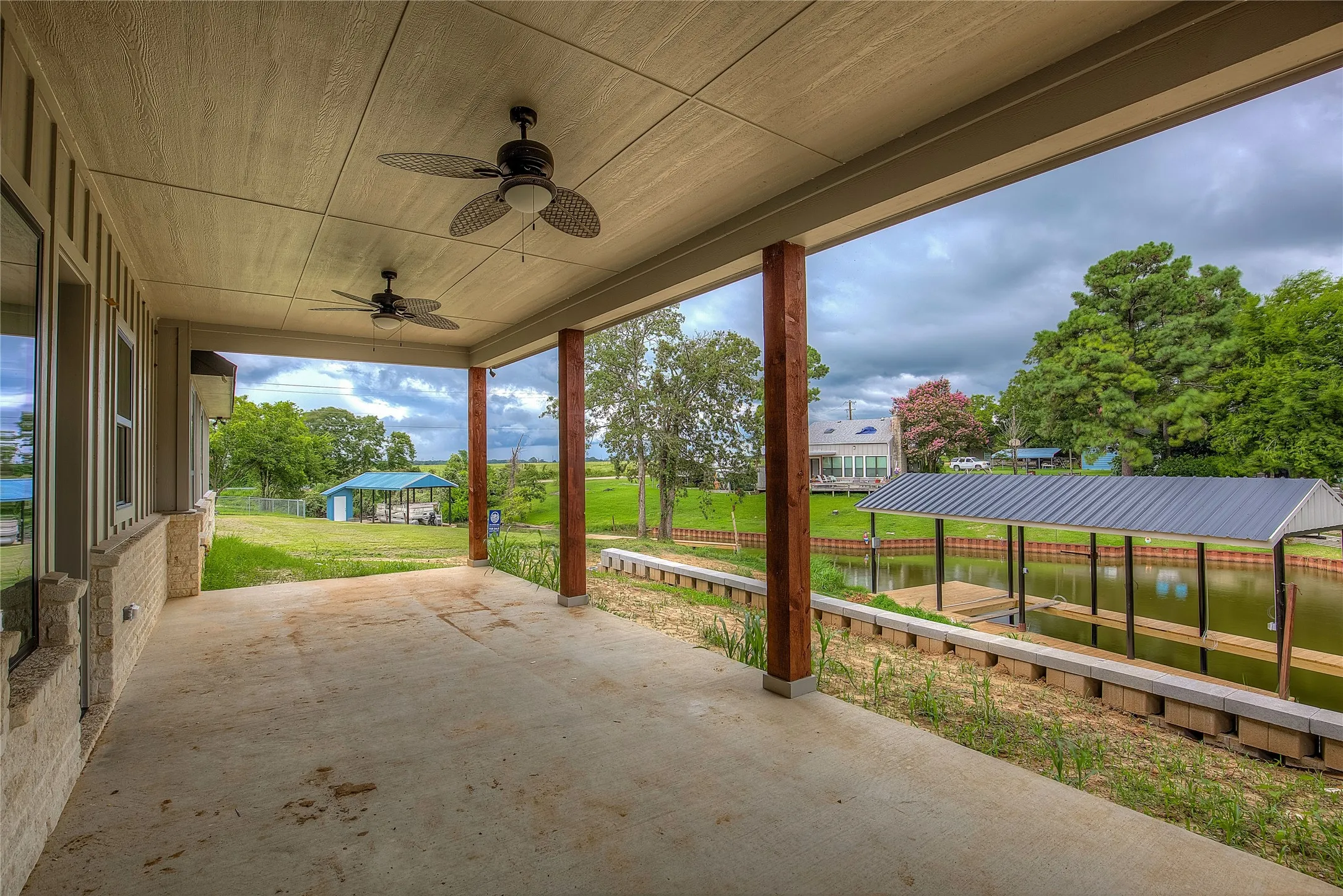 View of patio with a water view and ceiling fan