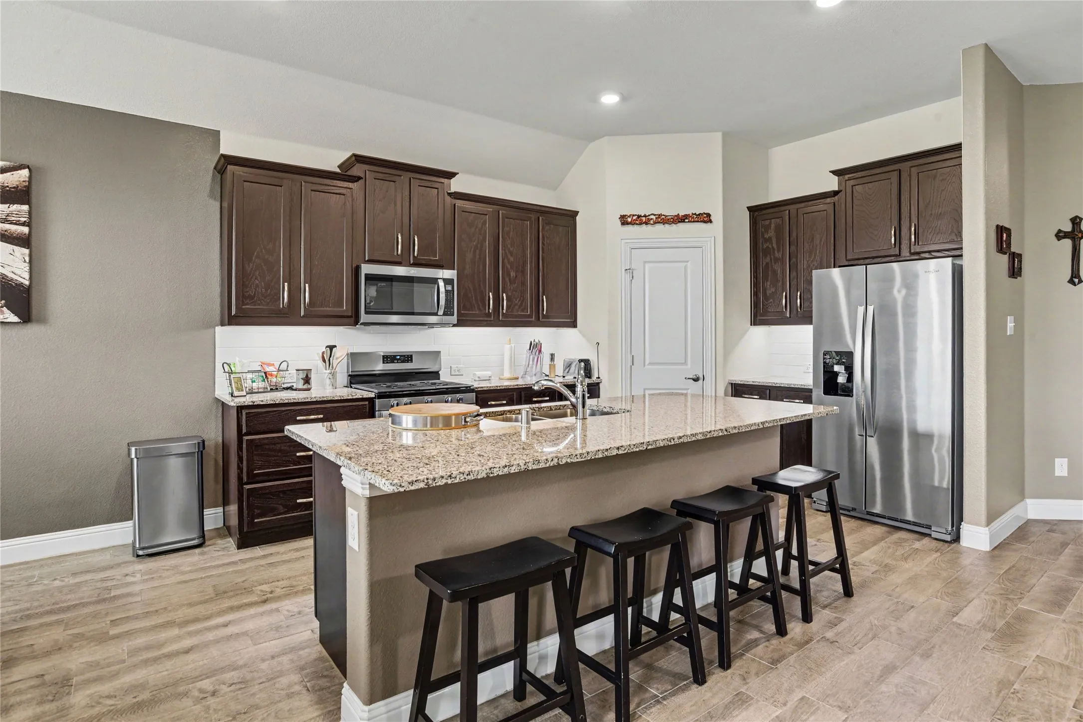 The open-concept kitchen overlooks the living and dining areas, making everyday living and entertaining effortless.