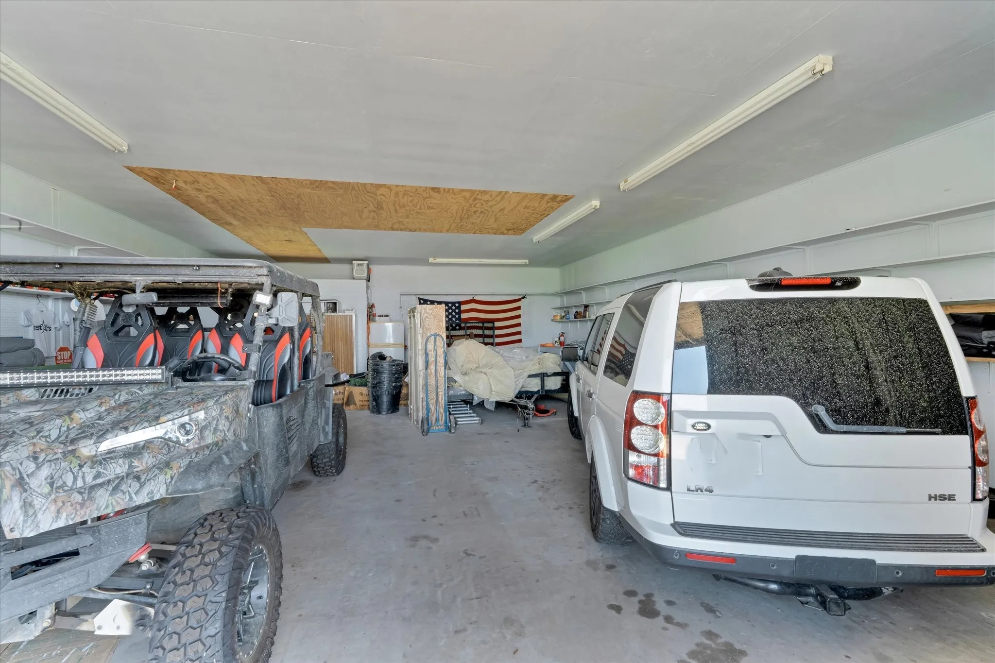 Concrete flooring with overhead fluorescent lighting and visible structural beams