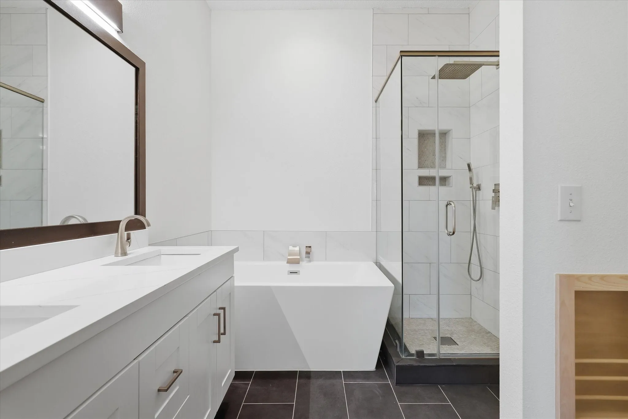 The updated Primary Bath offers quartz coutnertops, a standing tub and separate shower.