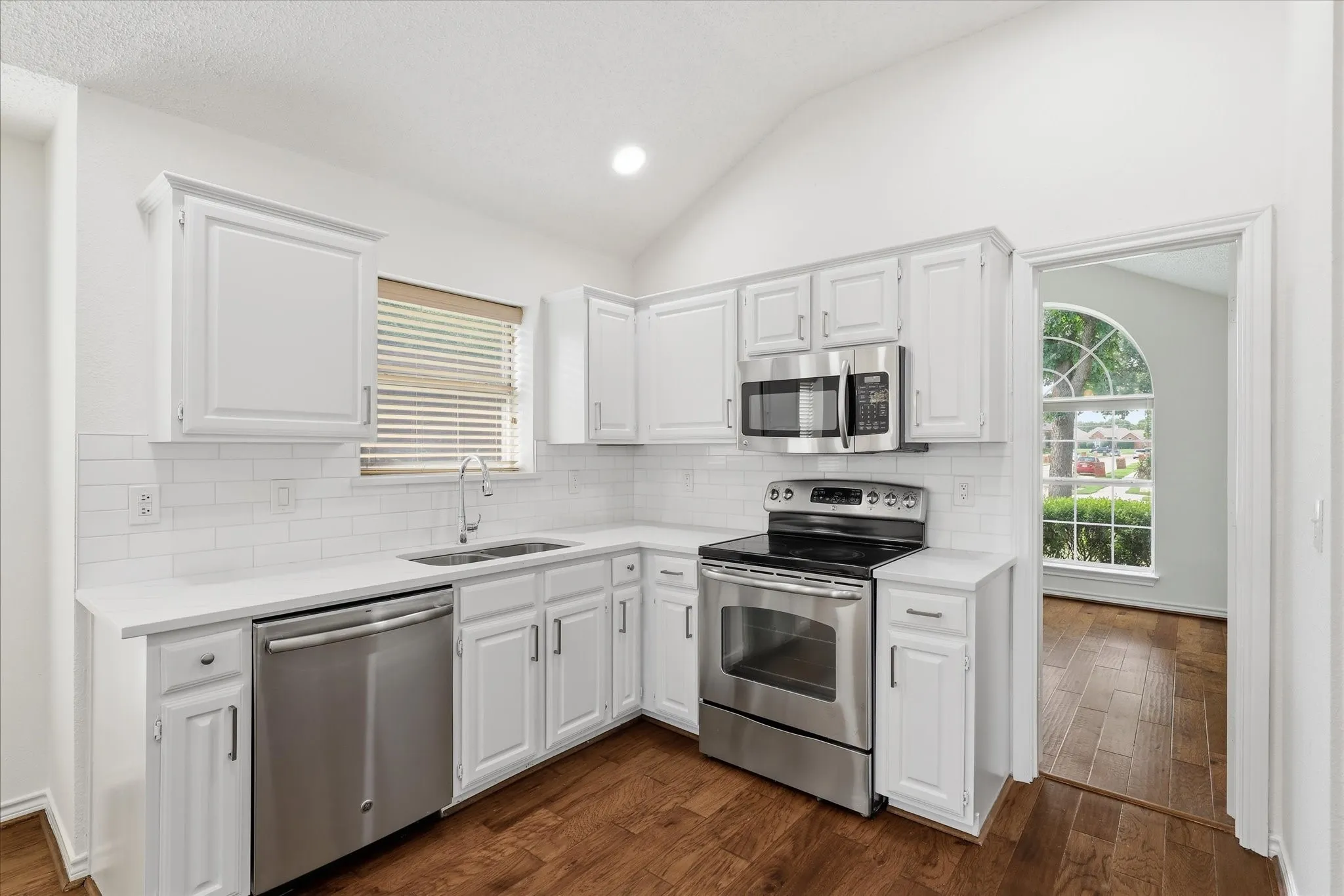 Up close Kitchen view with white subway tile backsplash.