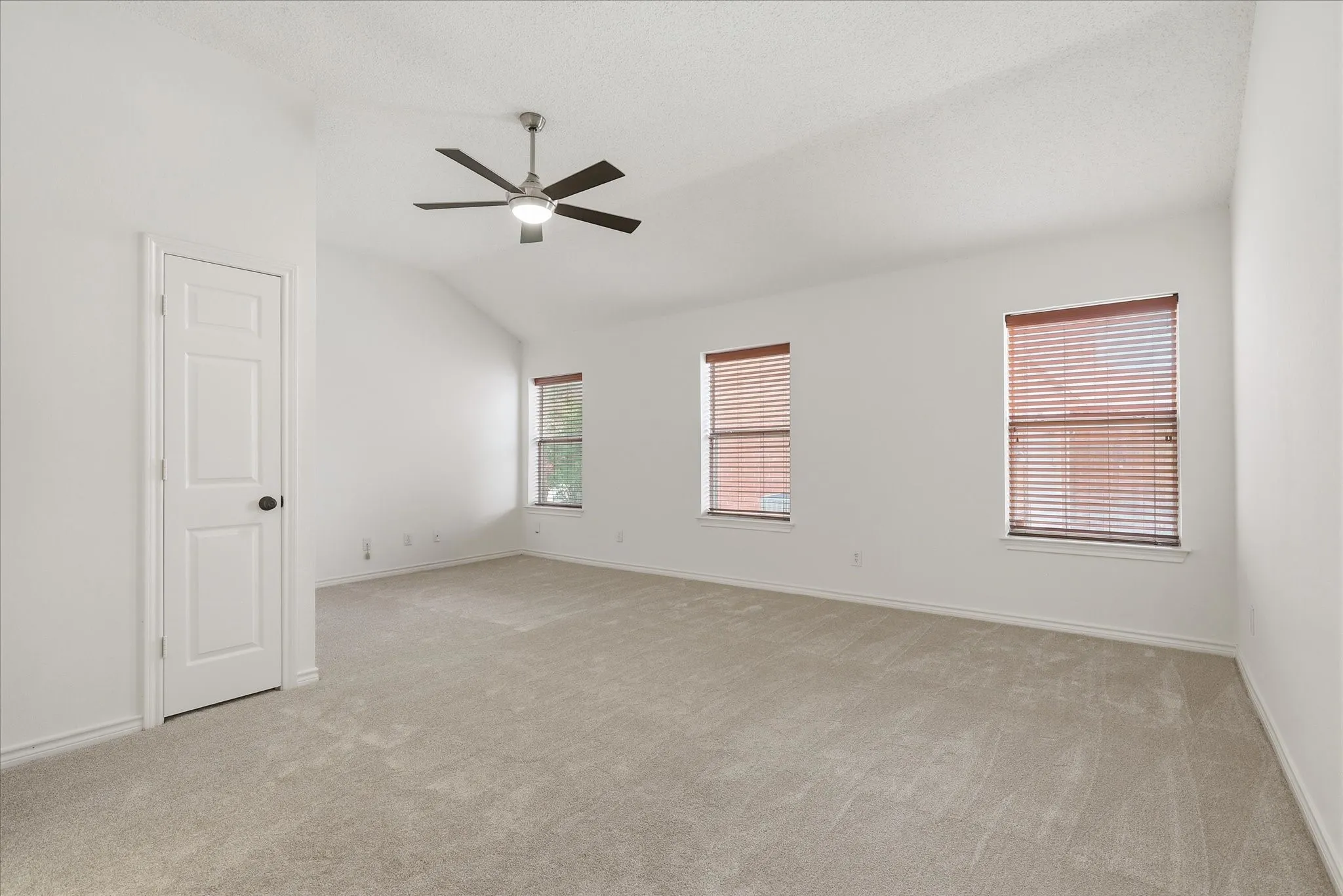 Primary Bedroom with new carpet offers a sitting area.