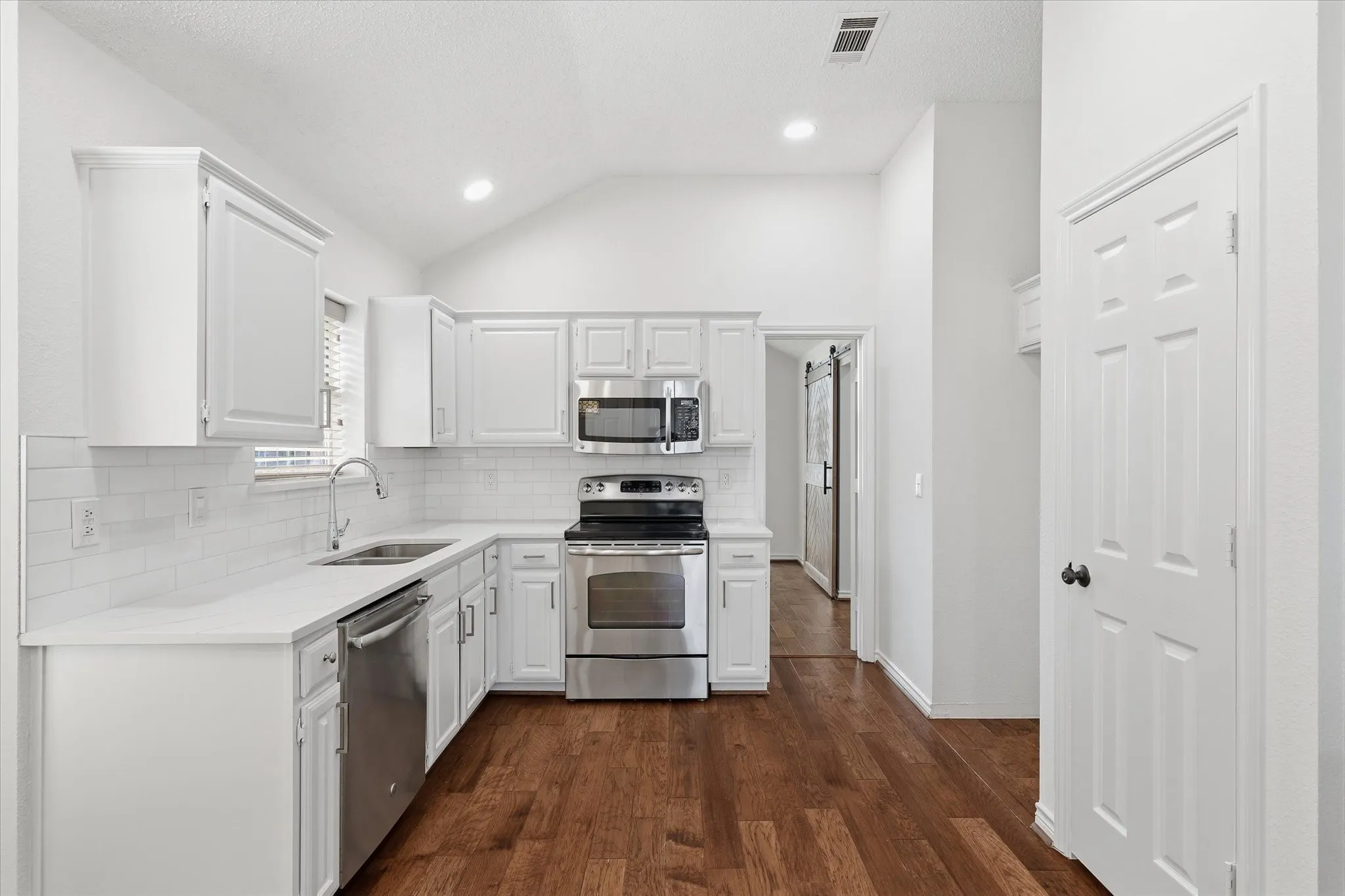 Kitchen and Pantry View, the Kitchen also features beautiful wood flooring.
