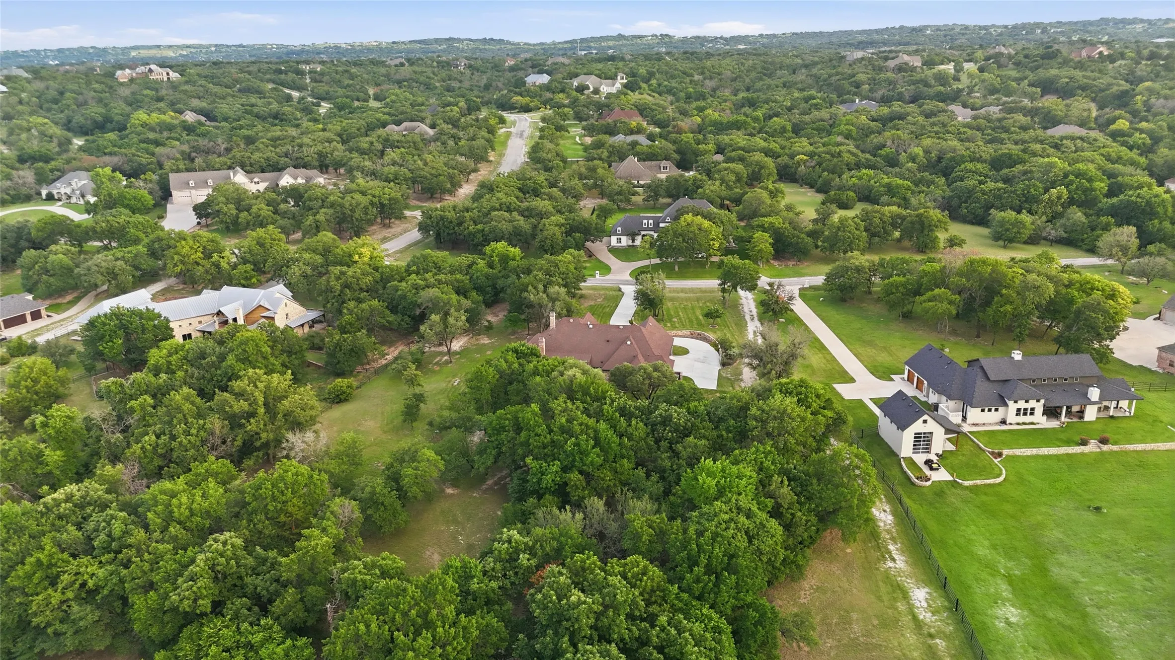 Expansive residential area featuring numerous properties surrounded by mature trees