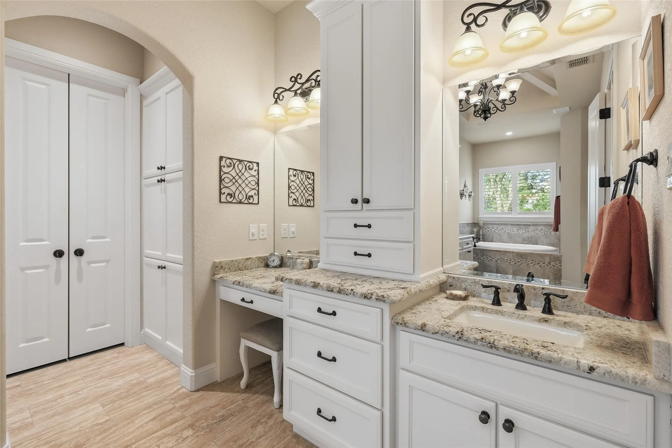 Bathroom vanity featuring a single undermount sink, granite countertop, and dark-finish faucet