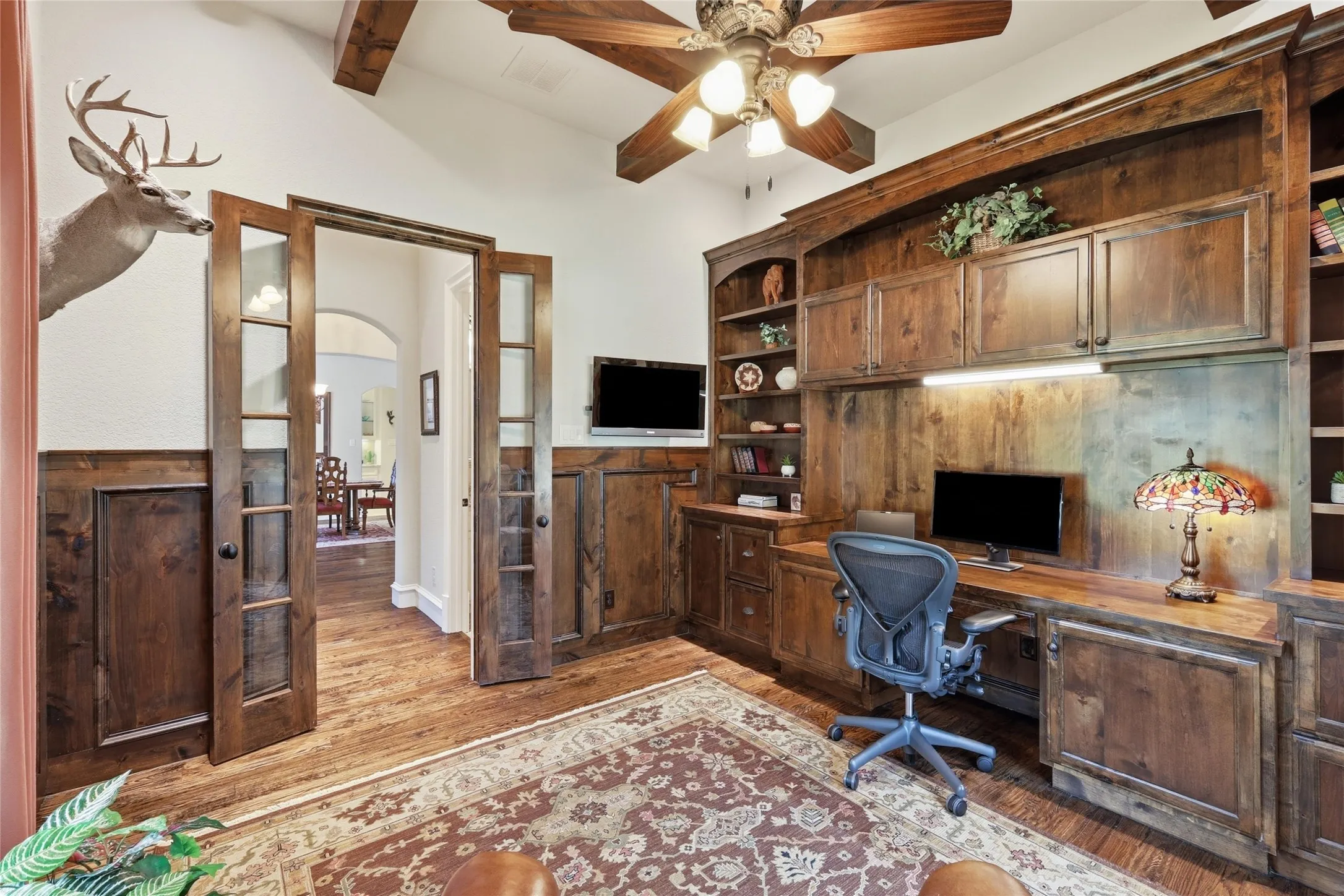 Custom wood-finish built-in cabinetry with integrated desk space and shelving