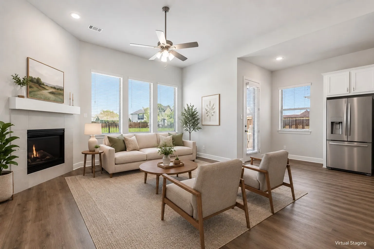 Open-concept living area featuring wood-finish flooring, a contemporary fireplace with a floating mantel, and abundant natural light from multiple windows