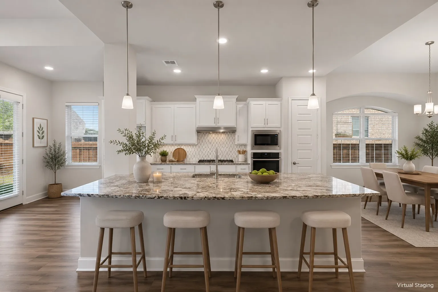 Kitchen featuring a spacious island with a speckled countertop, white cabinetry, built-in double ovens, and a tile​​‌​​​​‌​​‌‌​‌‌​​​‌‌​‌​‌​‌​​​‌​​ backsplash