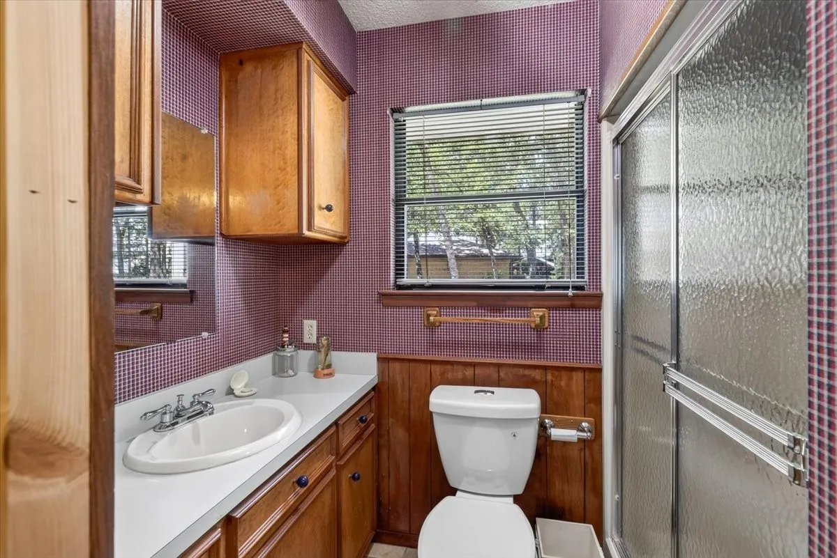 Guest quarters full Bathroom featuring a built-in vanity with a white countertop, an oval undermount sink, and cabinetry