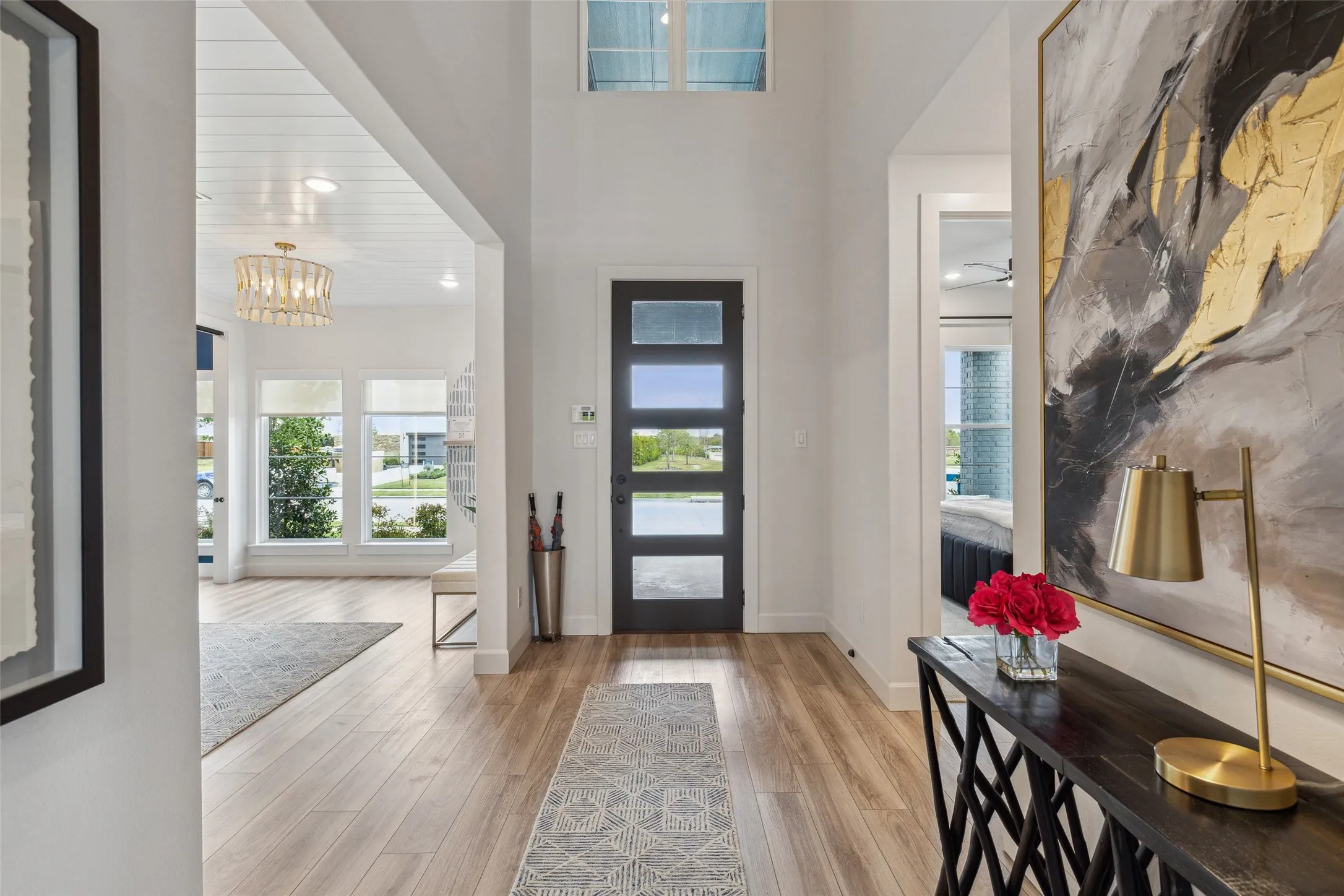 Featuring a beautiful wood and glass contemporary entry door, high ceilings and light colored flooring, welcoming friends and family into this dream home is a pleasure!