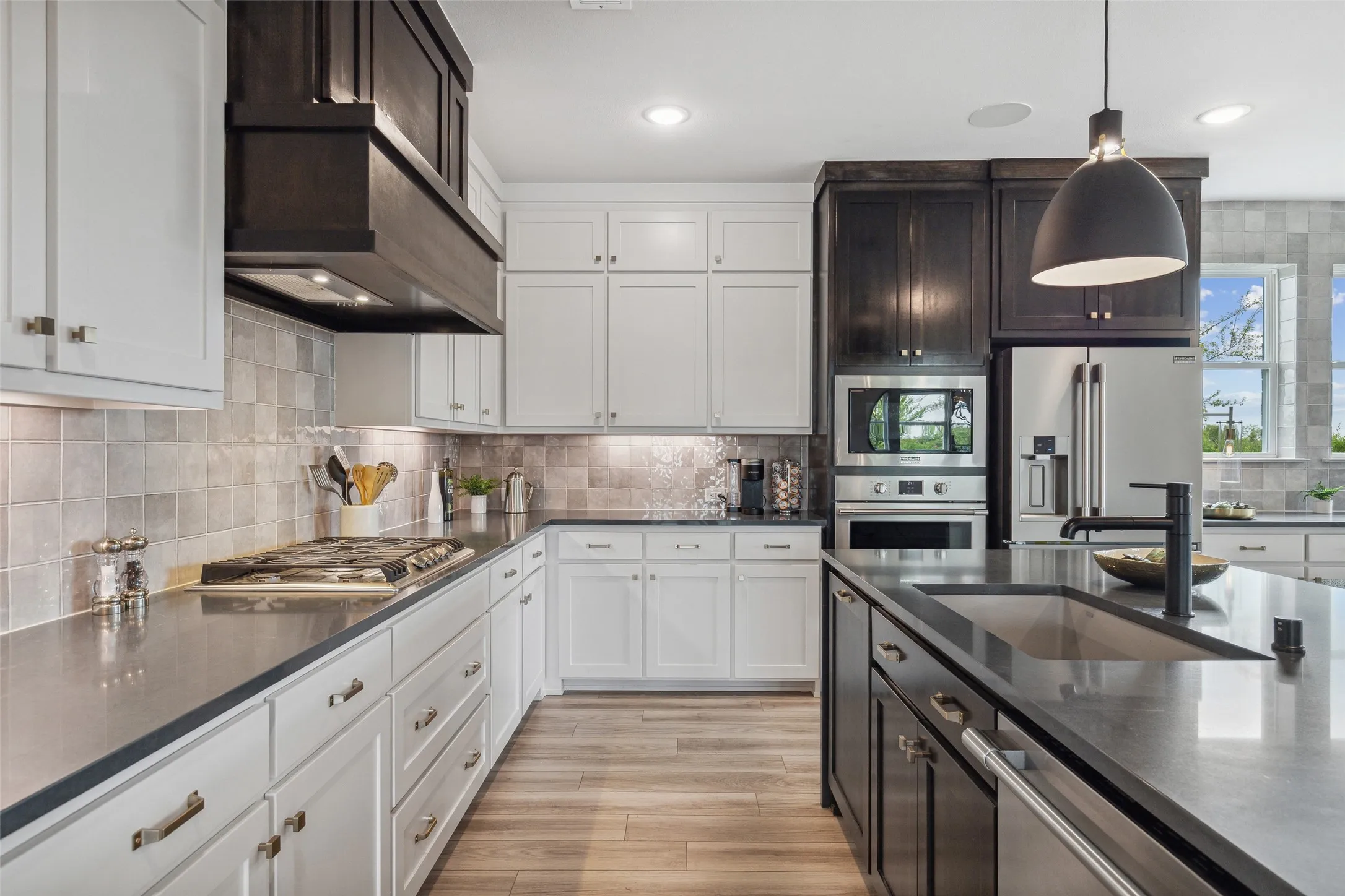 Gorgeous countertops, beautiful cabinetry and stylish backsplash effortlessly pair with contemporary stainless steel to create a kitchen for the ages!