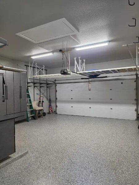 Spacious 3-car tandem garage with epoxy floor and abundant storage