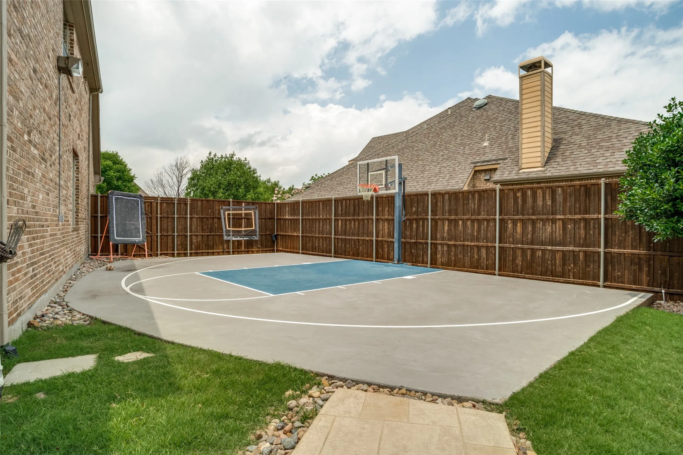 Sport court with basketball goal.