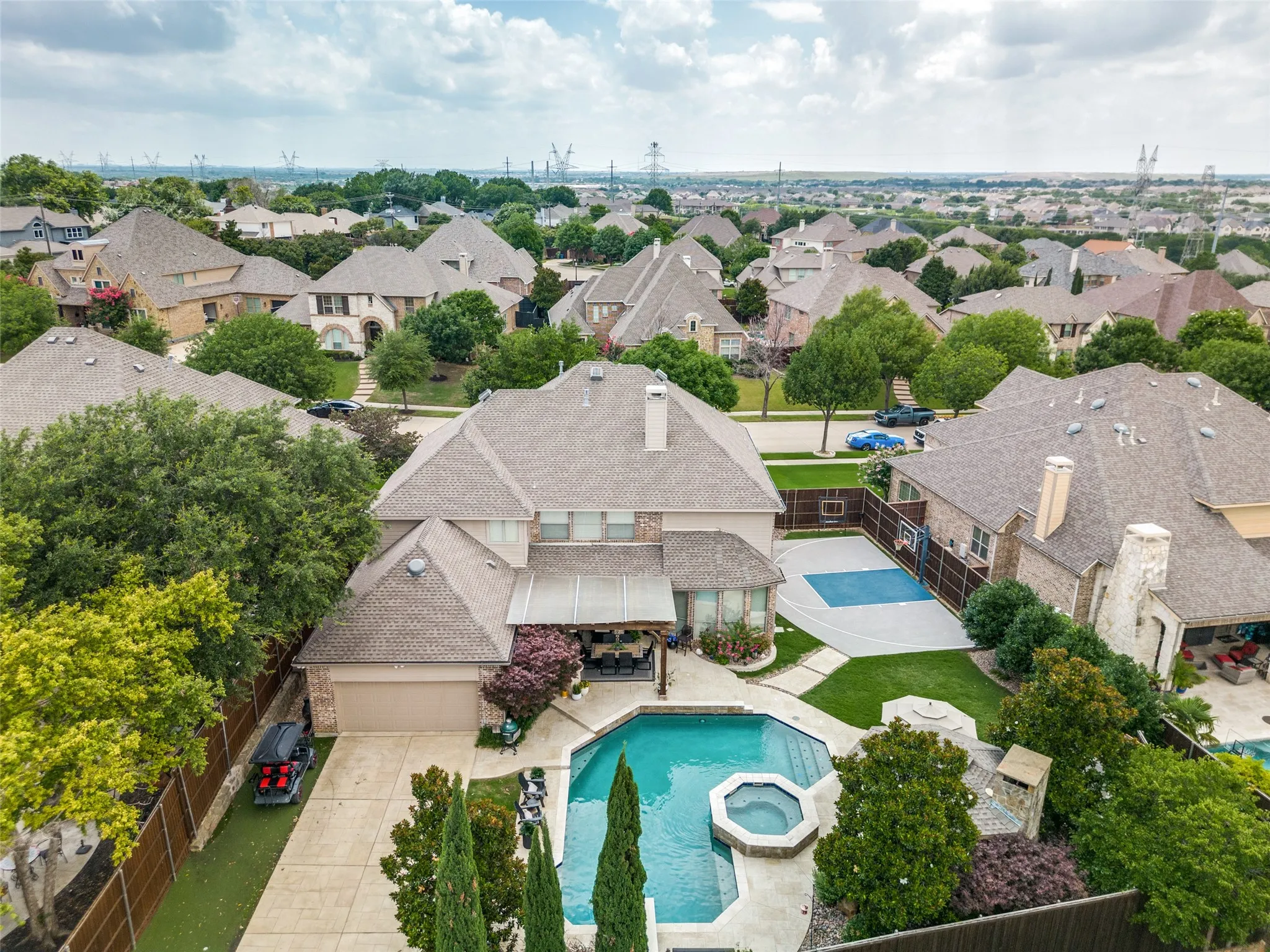 Gated, rear-entry drive leads to a spacious 3-car tandem garage with abundant storage to include a floored attic above and a lift system up to 250 lbs.