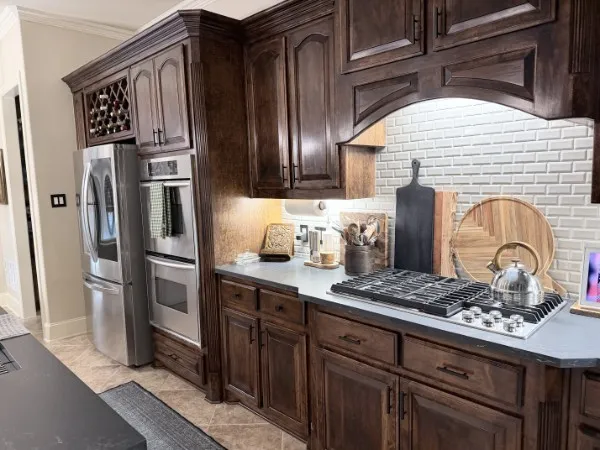 Stained hardwood cabinets, updated backsplash and quartzite countertops