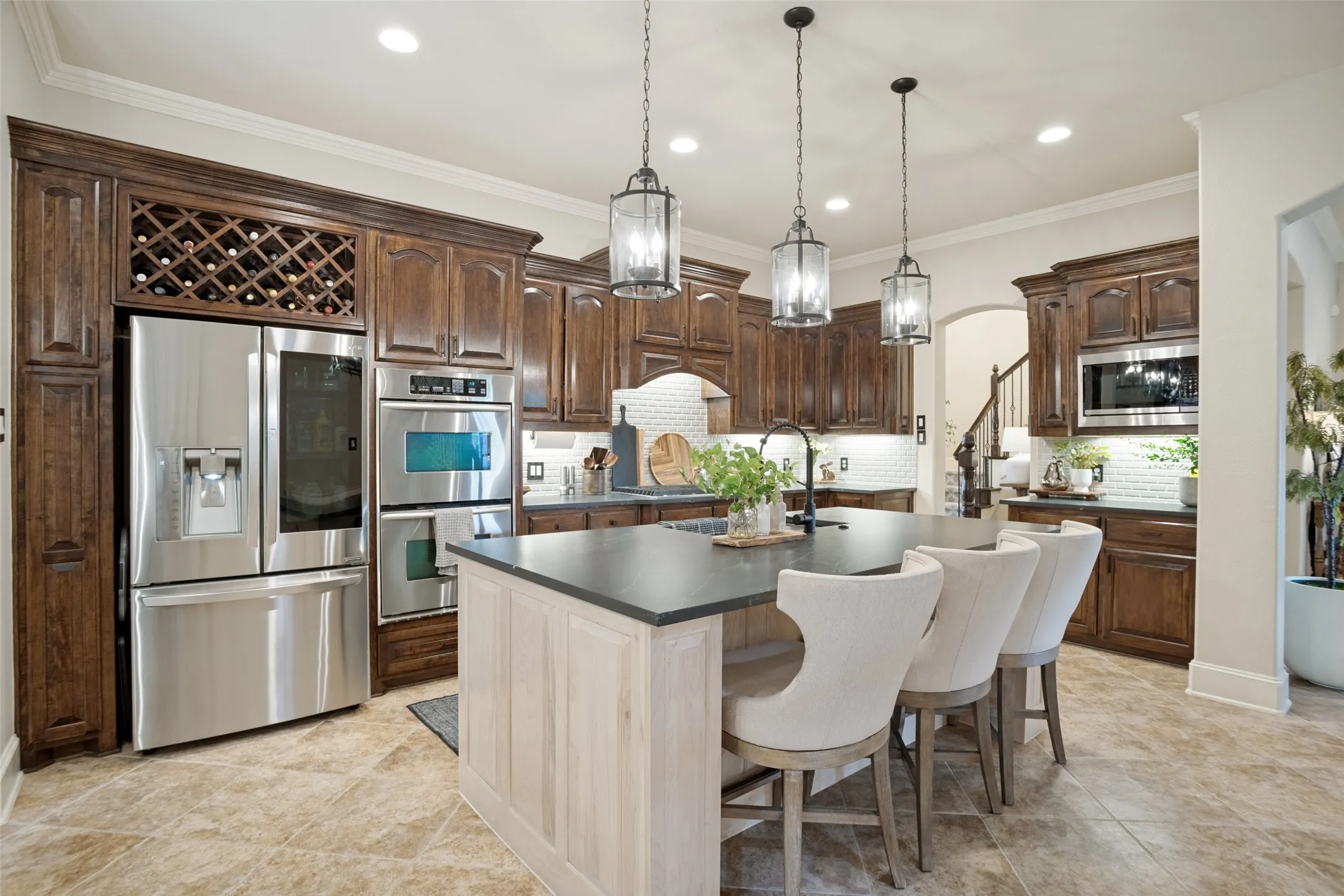 Stained hardwood cabinets, updated backsplash and quartzite countertops