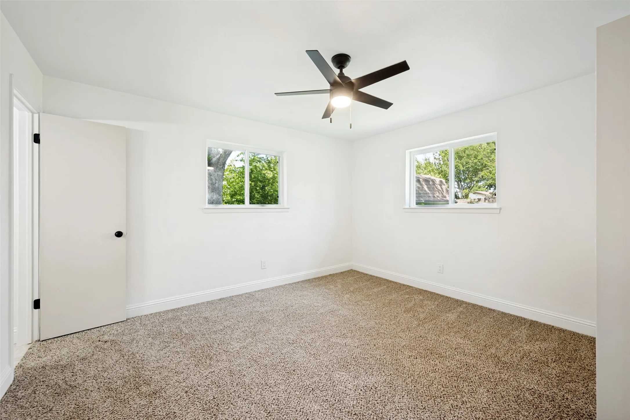 Neutral-toned carpeting paired with crisp white walls