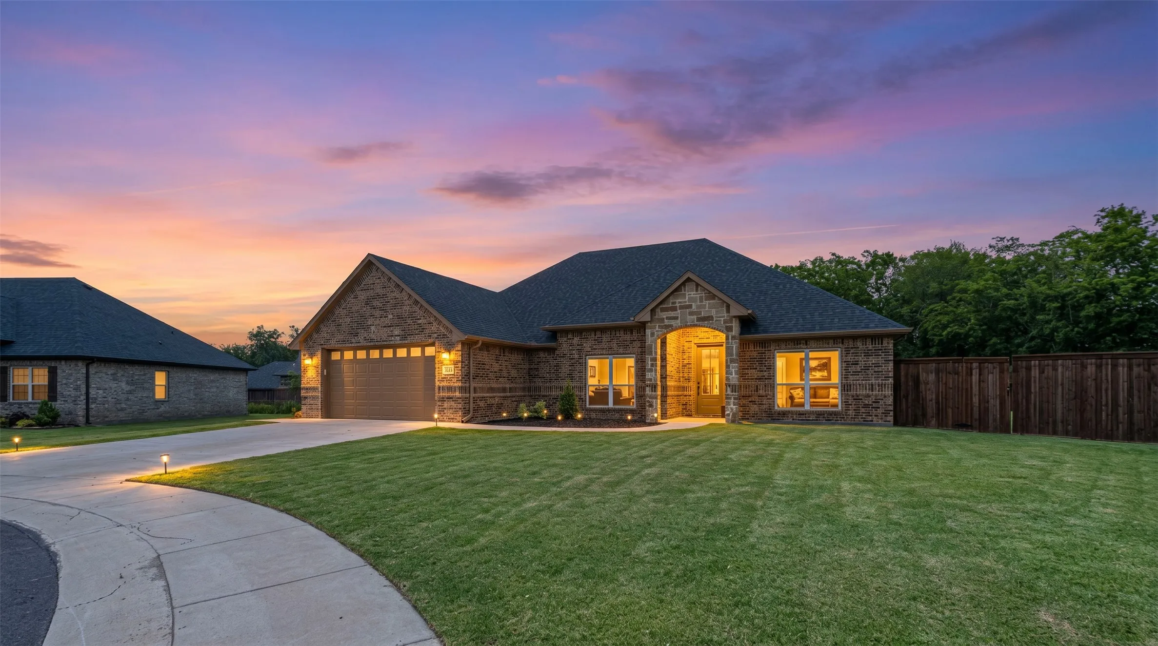 Stone-clad exterior featuring a two-car garage