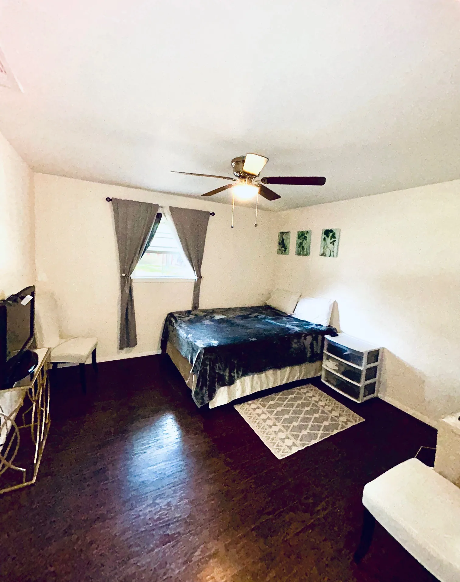 Bedroom with wood finished floors and a ceiling fan
