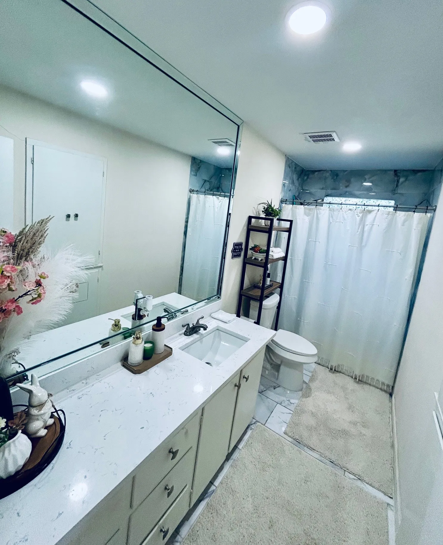 Bathroom featuring vanity, marble look tile flooring, a shower with curtain, and recessed lighting