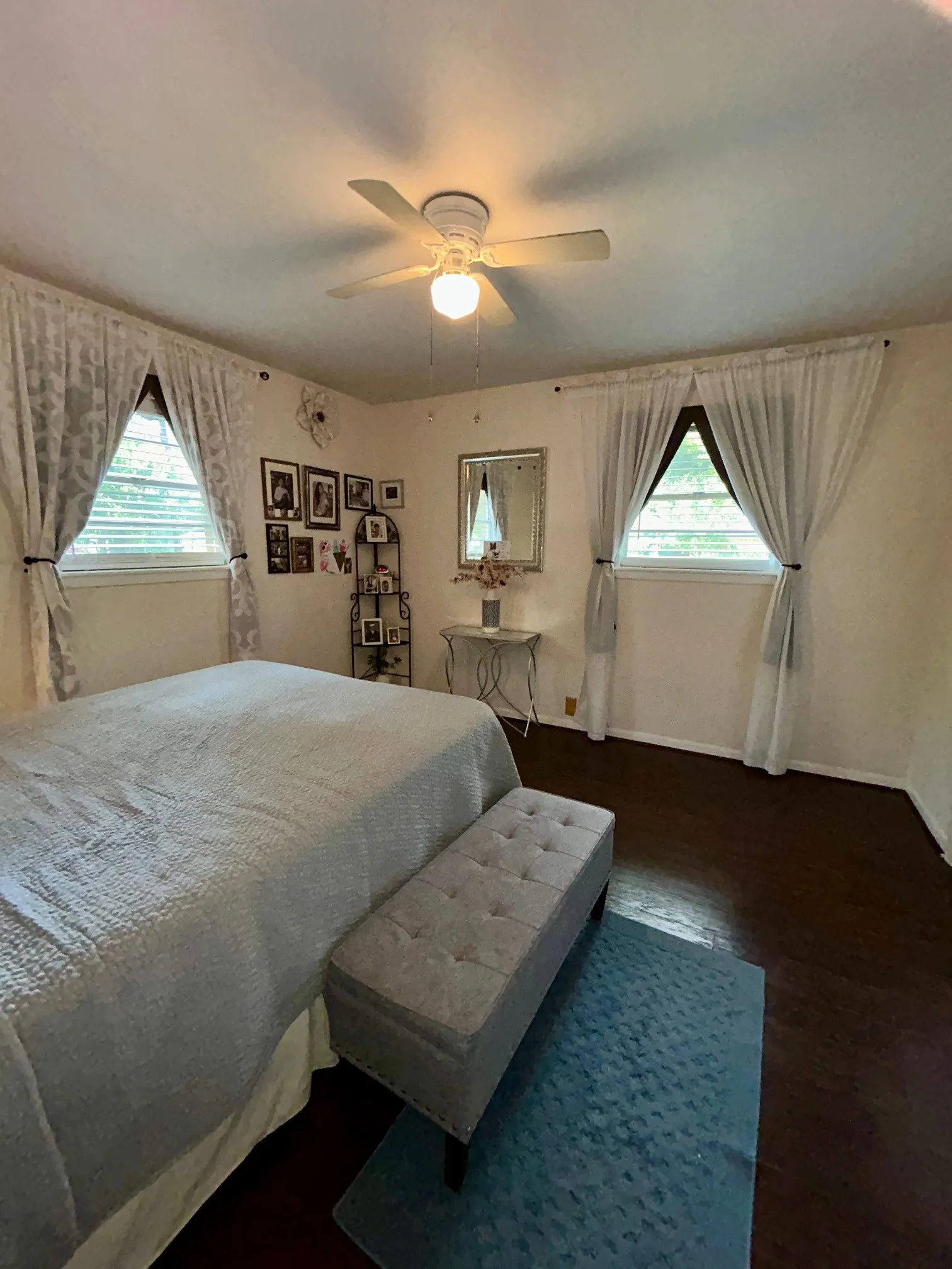 Bedroom featuring multiple windows, a ceiling fan, and wood finished floors