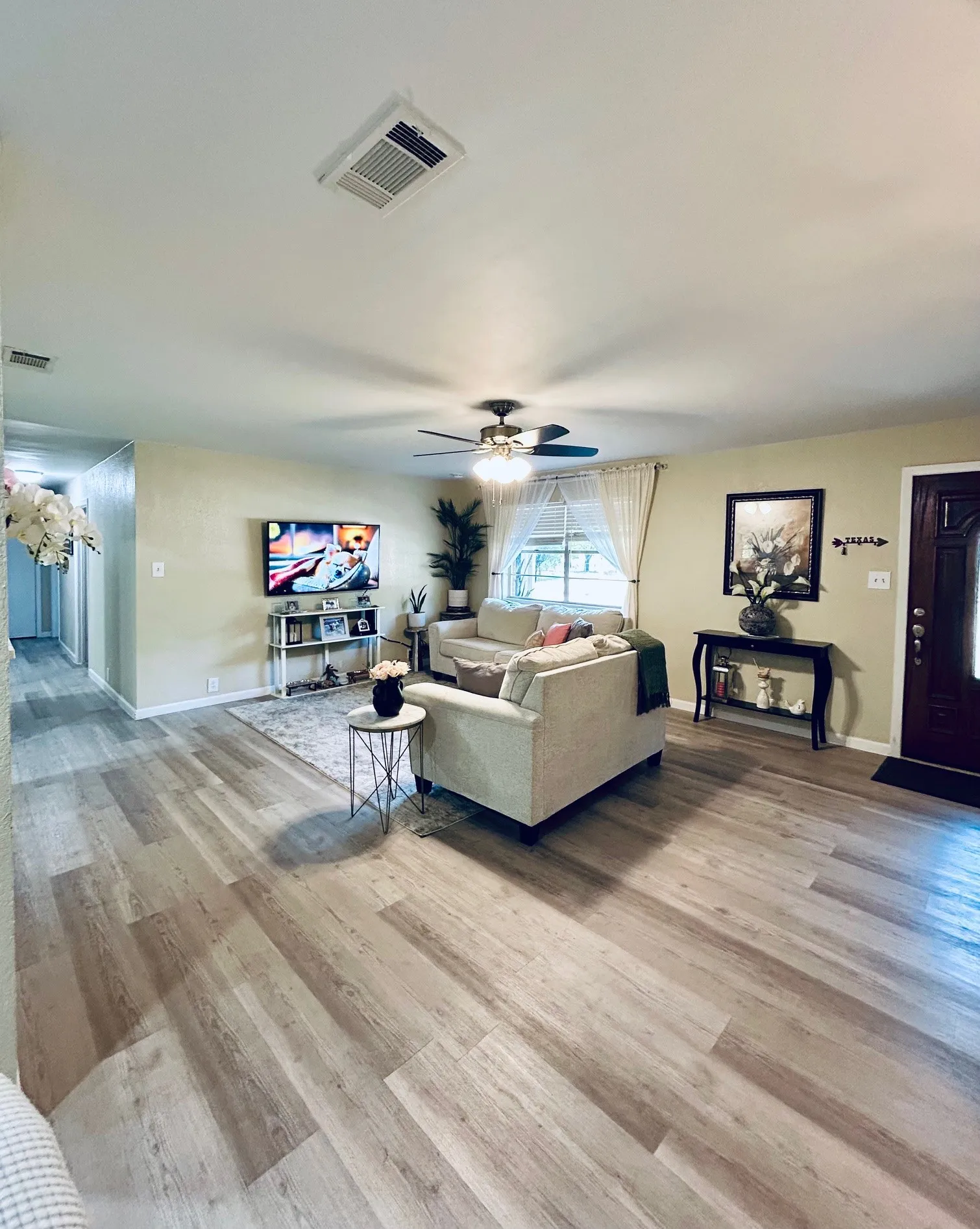 Living room with wood finished floors and a ceiling fan