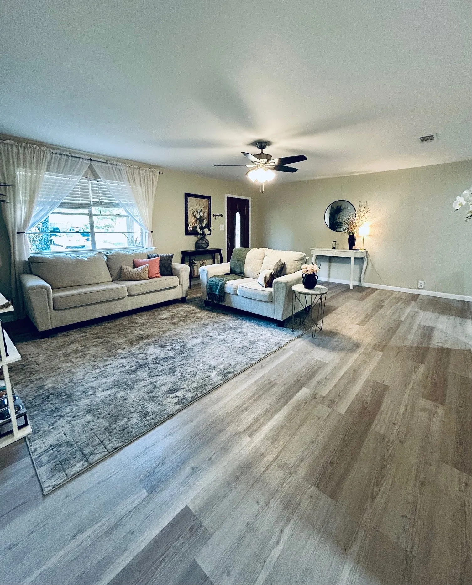 Living room featuring wood finished floors and ceiling fan
