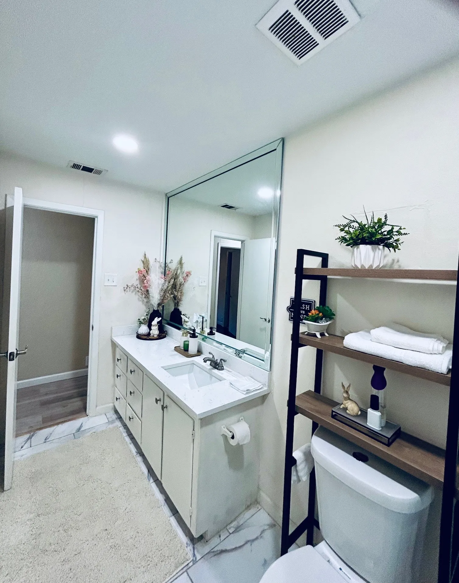 Bathroom with vanity and marble look tiles