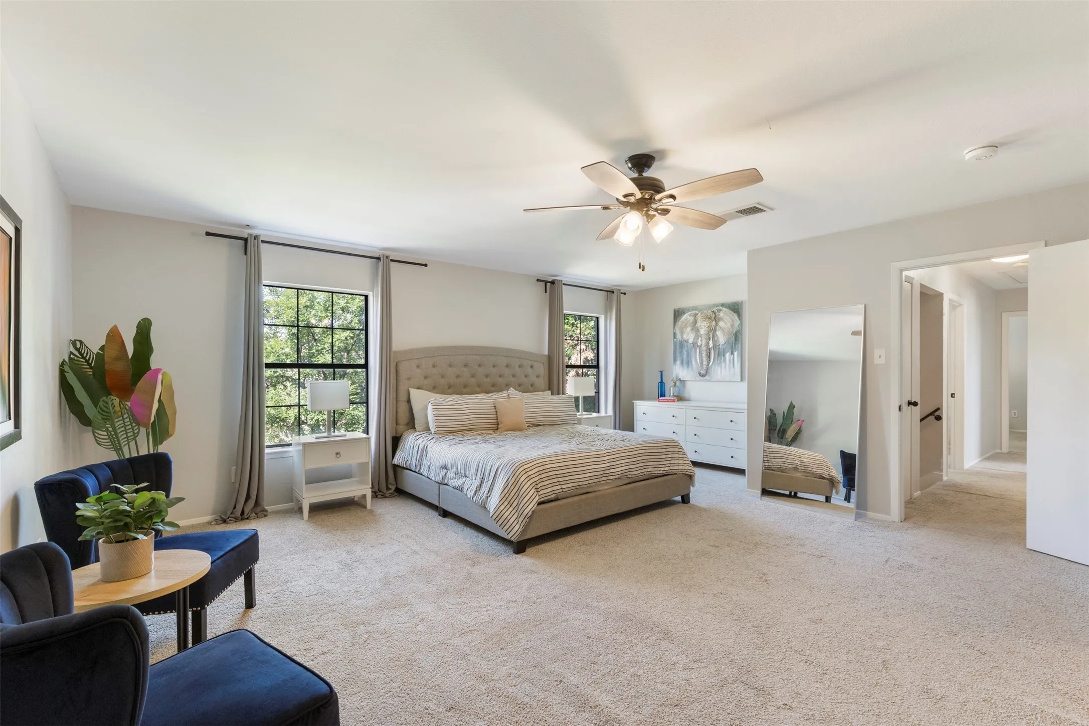 Spacious room featuring neutral carpeting and light gray wall tones