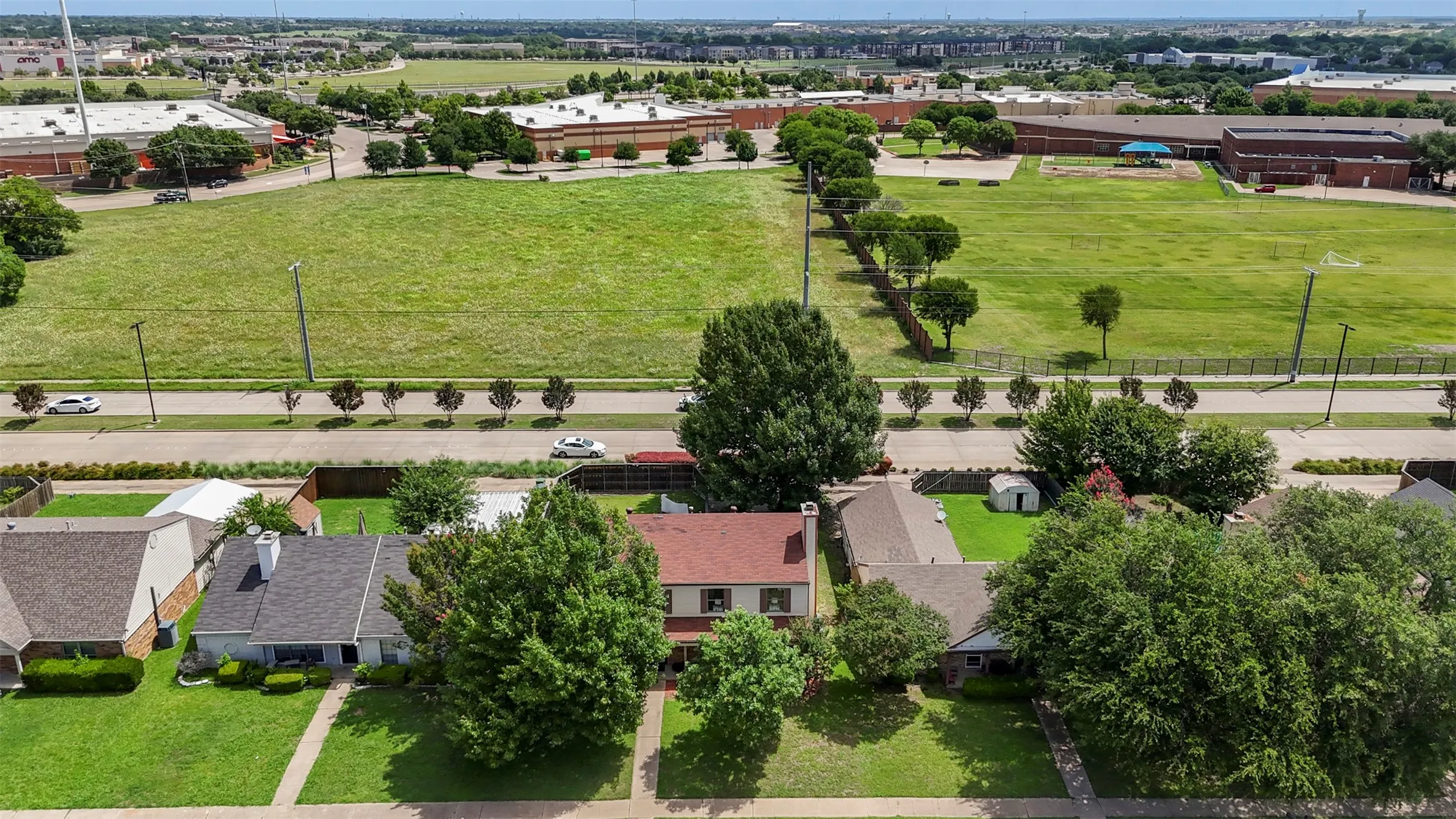 Aerial perspective showcasing the residential street with a mix of single-story and two-story homes